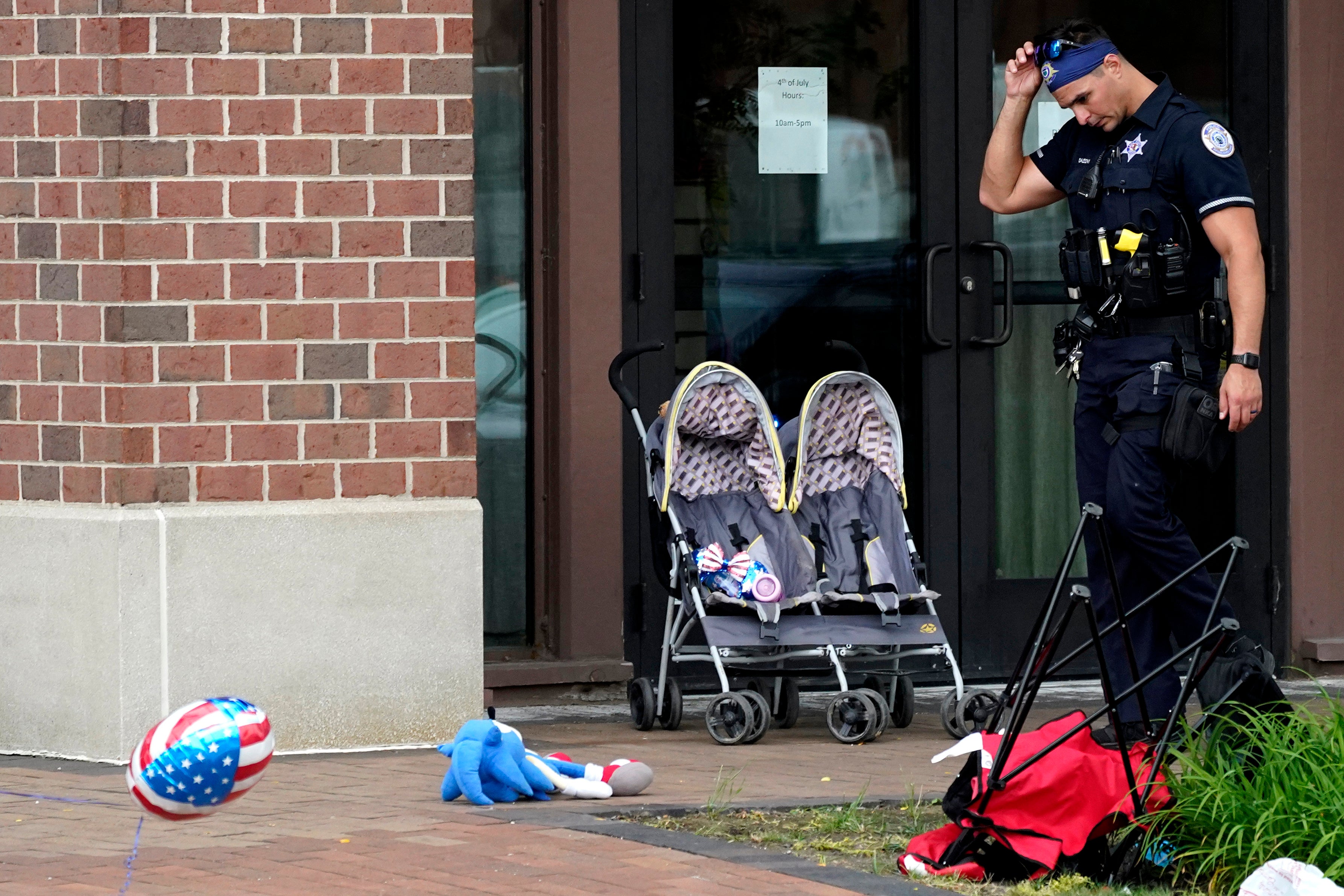 An officer reacts as a pram and other items are left strewn along the parade route