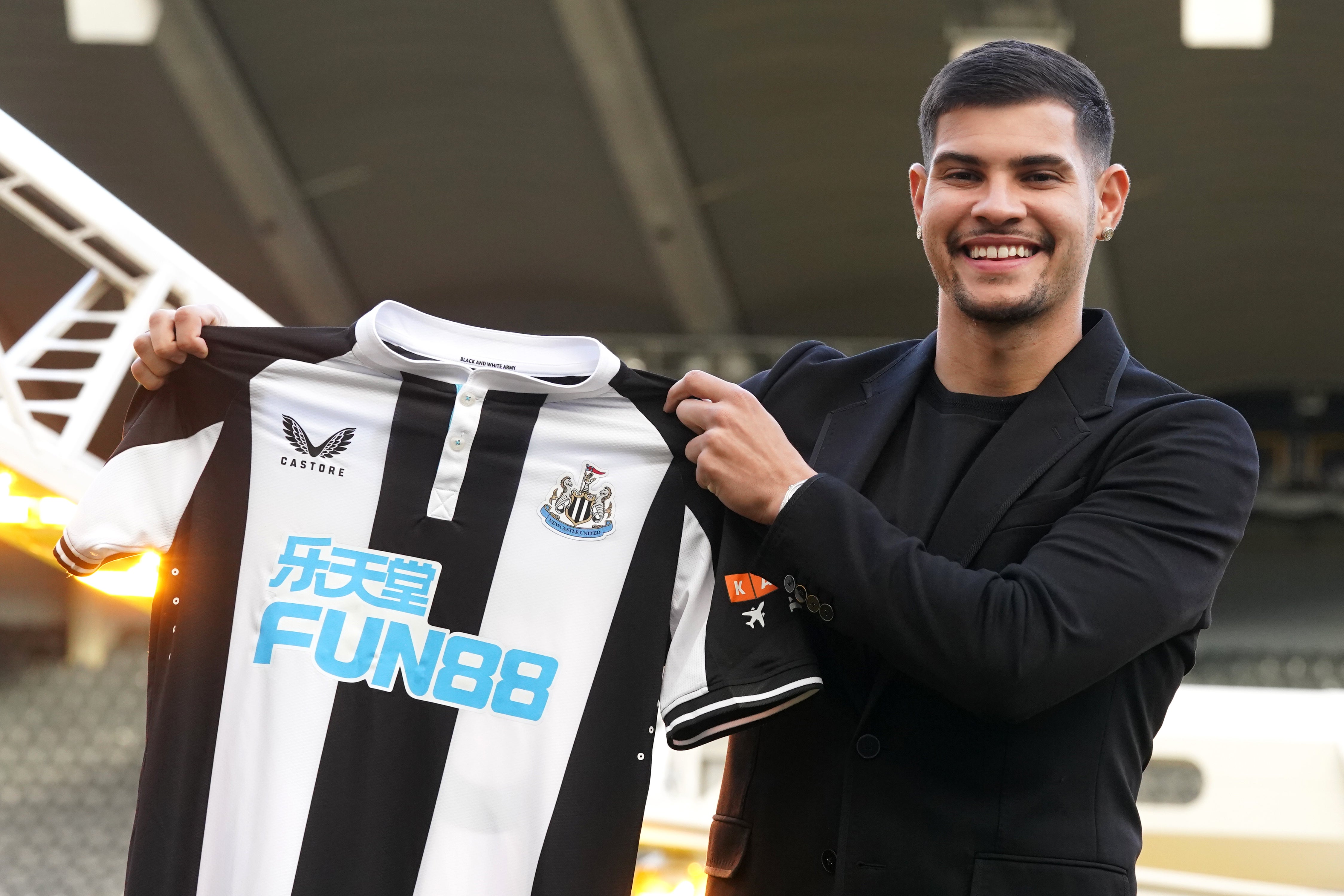 Bruno Guimaraes holds the shirt of Newcastle, who are among those with betting firm sponsorship (Owen Humphreys/PA)