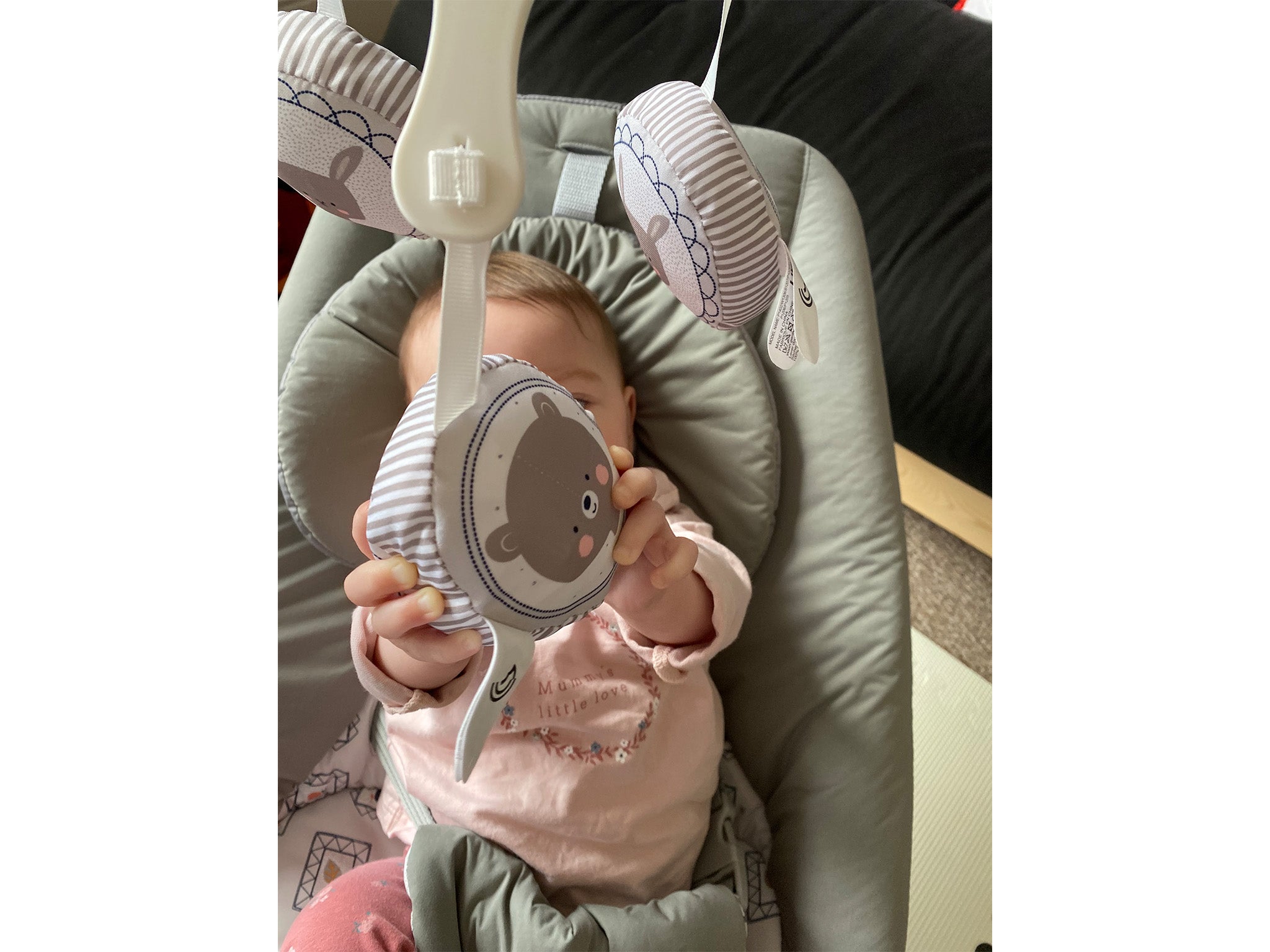 The toy bar can be manipulated into place above baby’s head