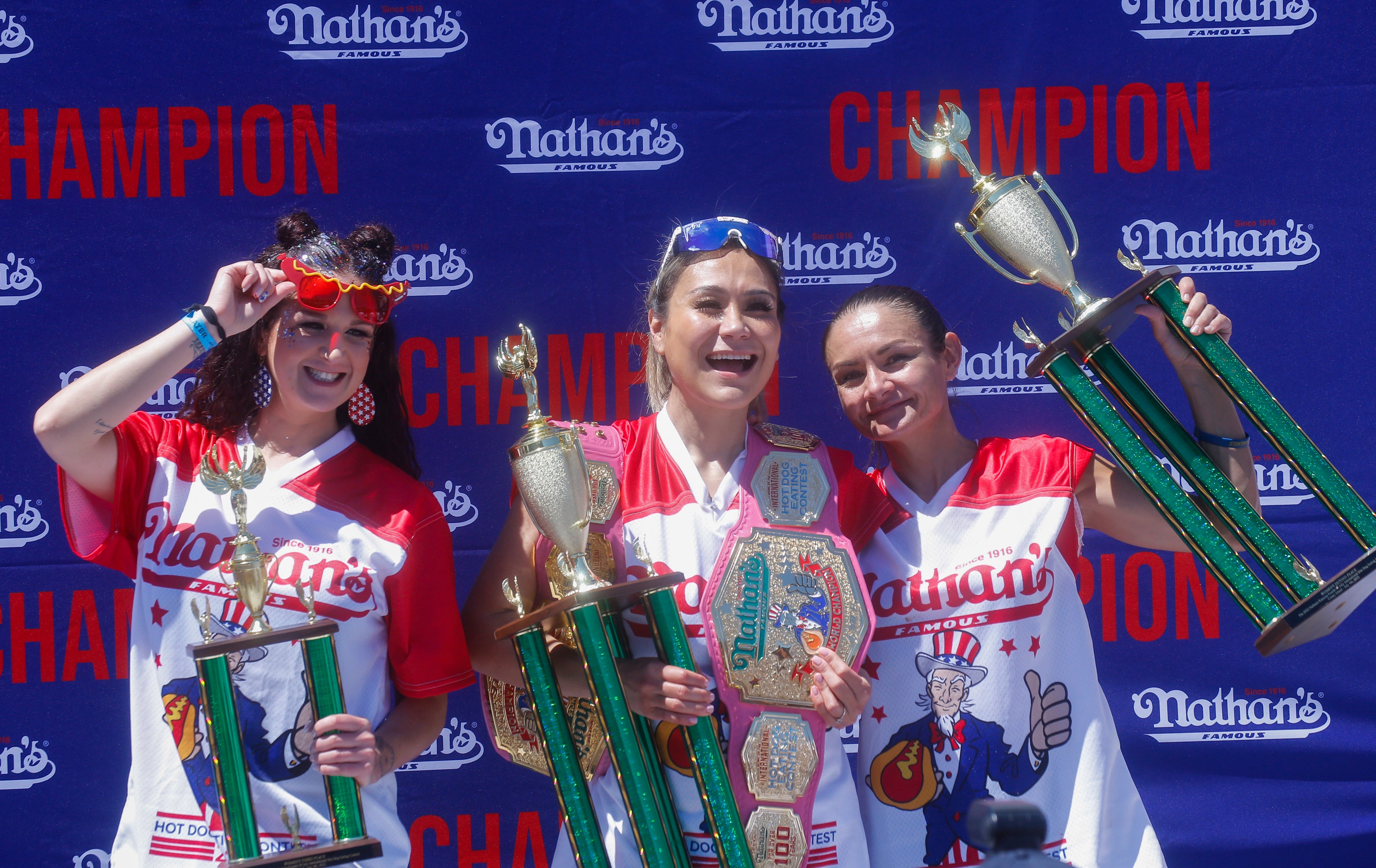 Miki Sudo (C) poses after she won first place, eating 40 hot dogs in 10 minutes, during the 2022 women's Nathan's Famous Fourth of July International Hot Dog Eating Contest on July 4, 2022