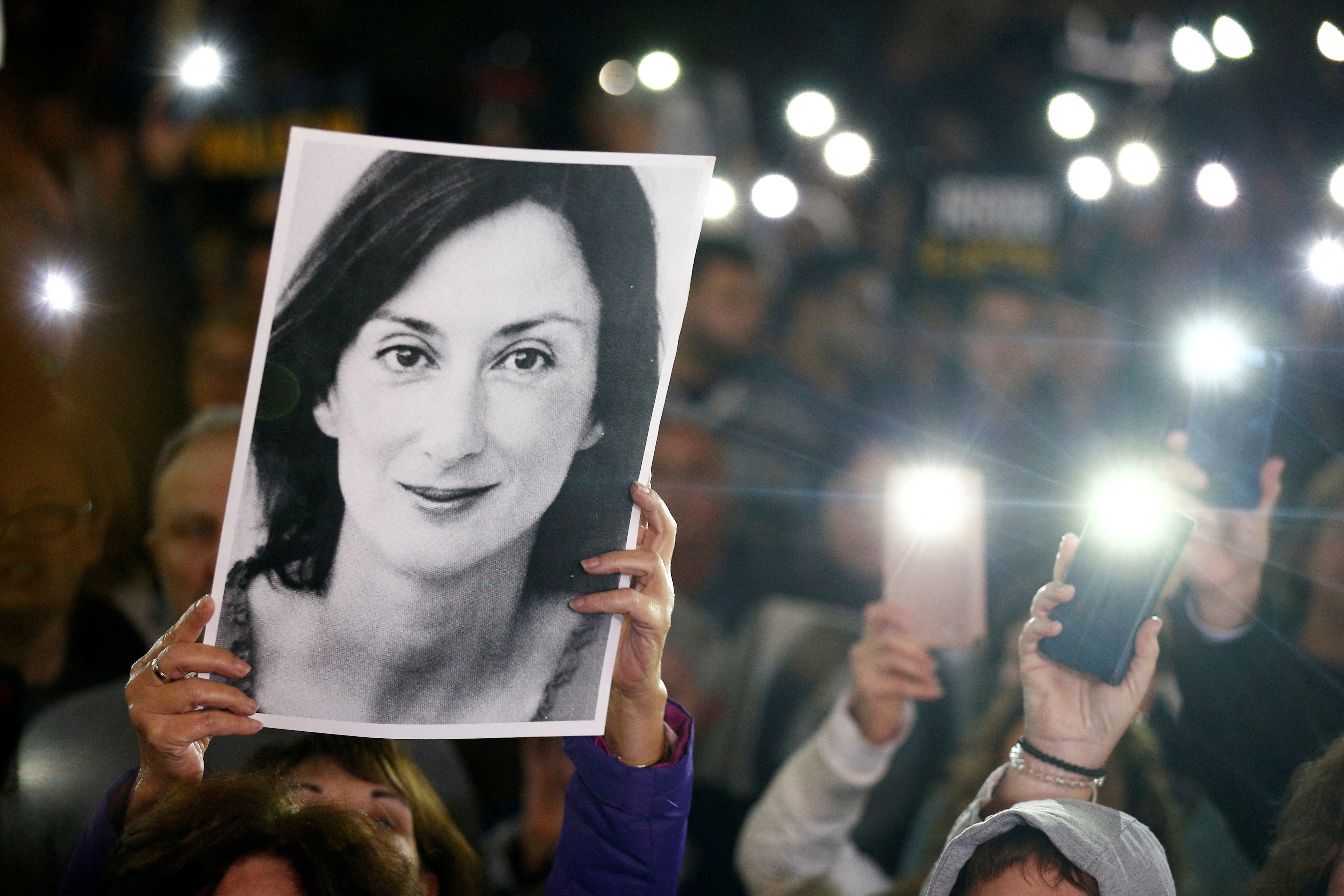 People gather at the Great Siege Square during a protest following the arrest of one of the country’s most prominent businessmen as part of the investigation into the murder of journalist Daphne Caruana Galizia