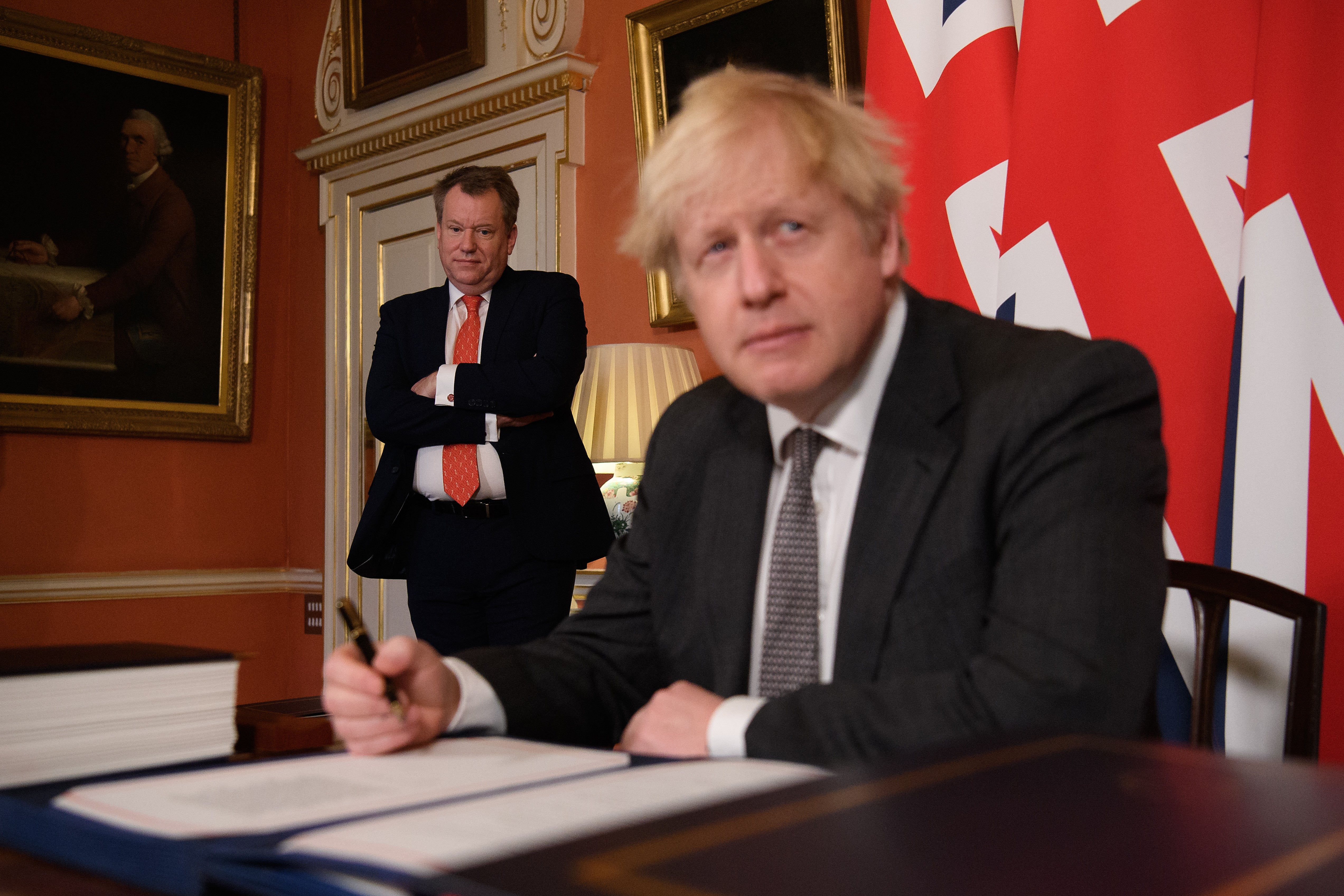 UK chief trade negotiator David Frost looks on as Boris Johnson signs the EU-UK Trade and Cooperation Agreement in 2020