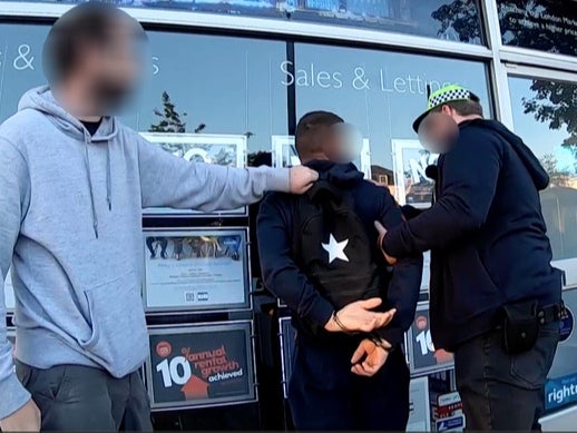 A suspect being arrested in Catford, London, as part of a Europe-wide operation against small boat people smugglers on 5 July 2022