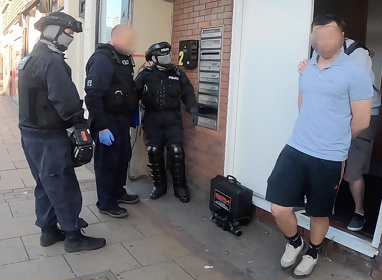 A man being detained in Catford, London, as part of Operation Punjum (National Crime Agency/PA)