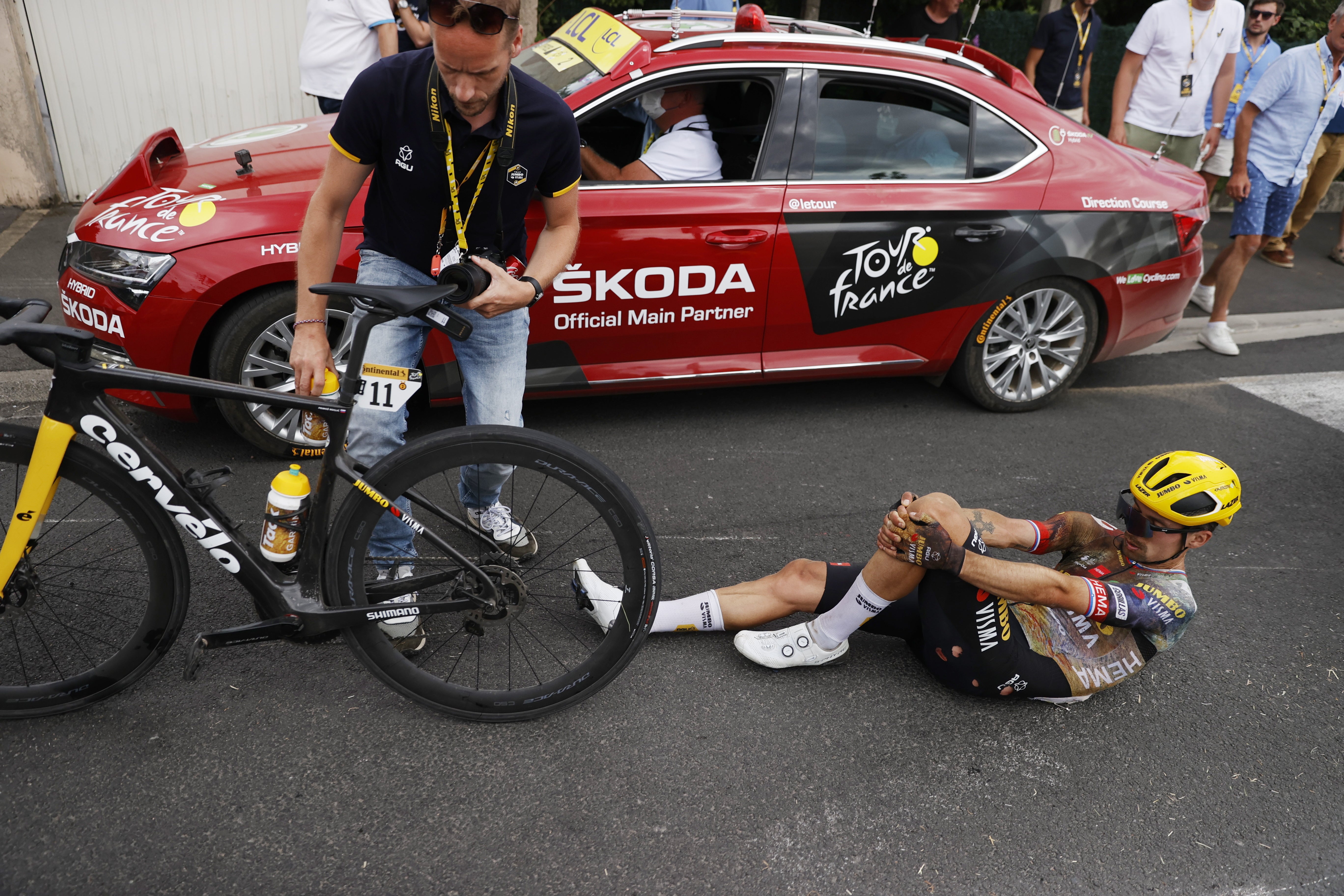 Primoz Roglic on the road after a crash near the end of stage five