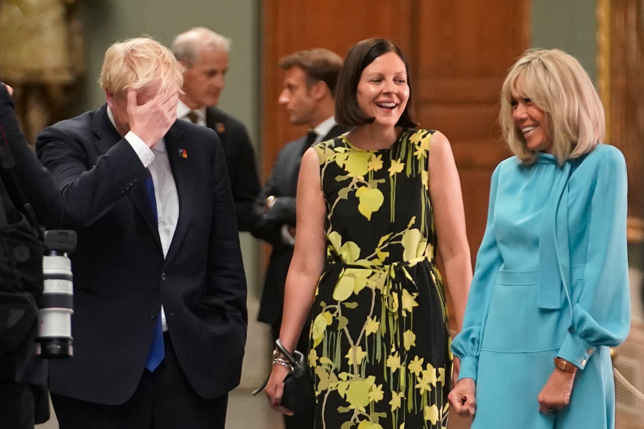 Boris Johnson speaks with Annik Penders (centre), the wife of Belgian premier Alexander De Croo, and Brigitte Macron, wife of the French president in Madrid