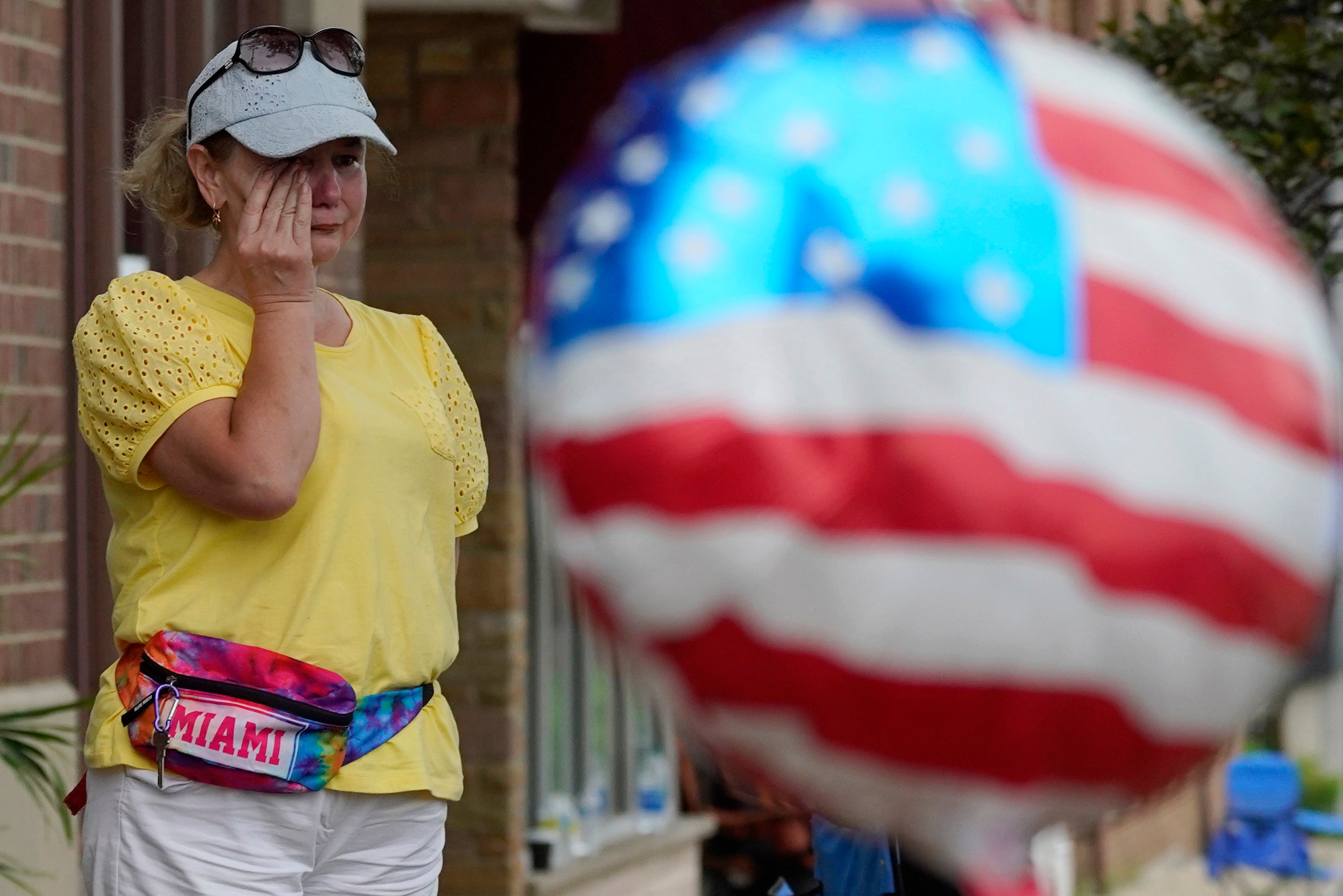 Woman wipes away tears at the scene of the mass shooting