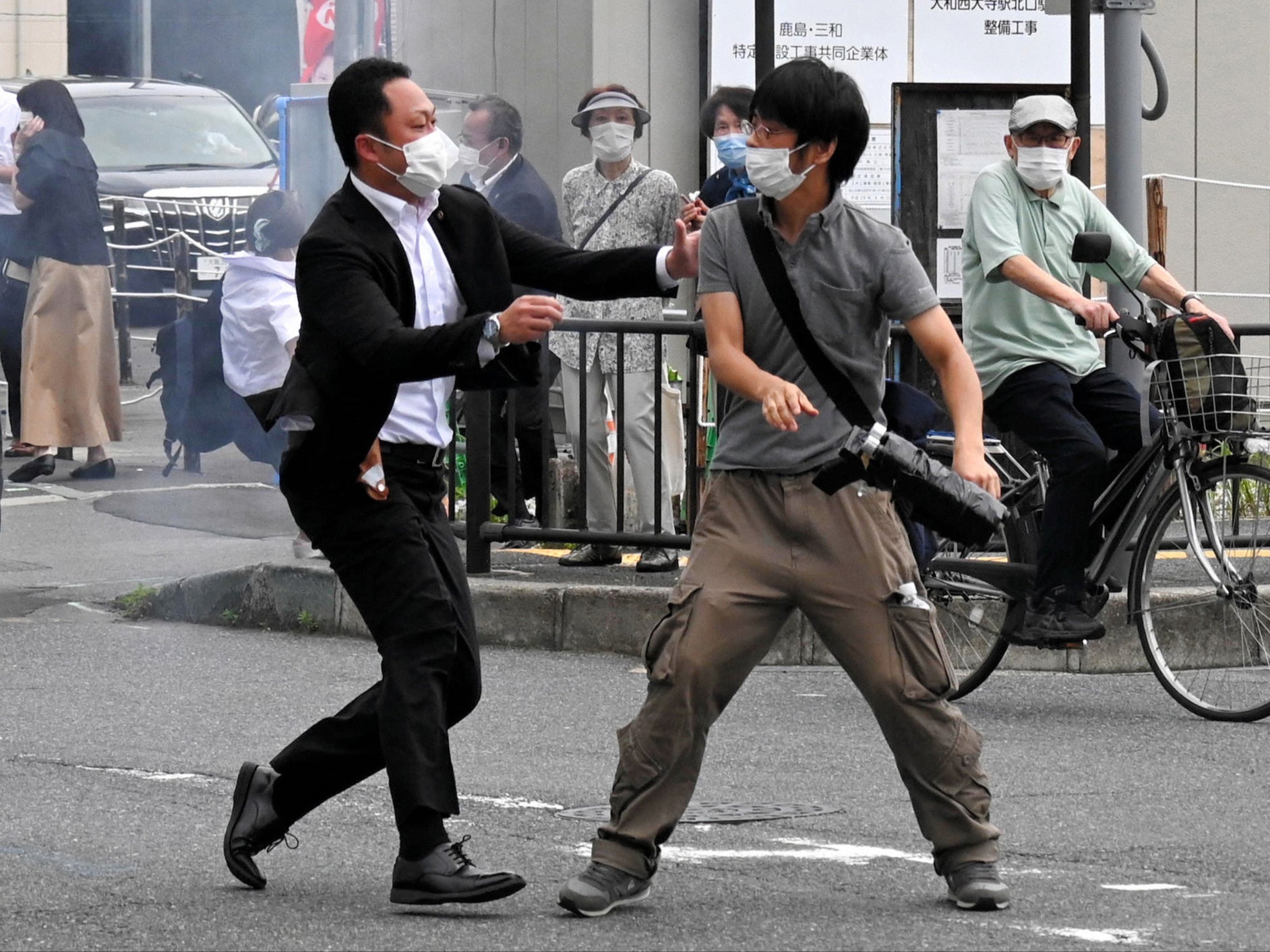 Police officer seizes suspect Tetsuya Yamagami in front of Yamatosaidaiji Station on 8 July in Nara, Japan