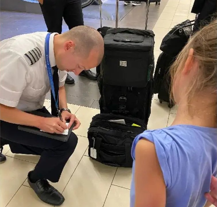 Captain Josh Duchow writes Lena a note for the tooth fairy