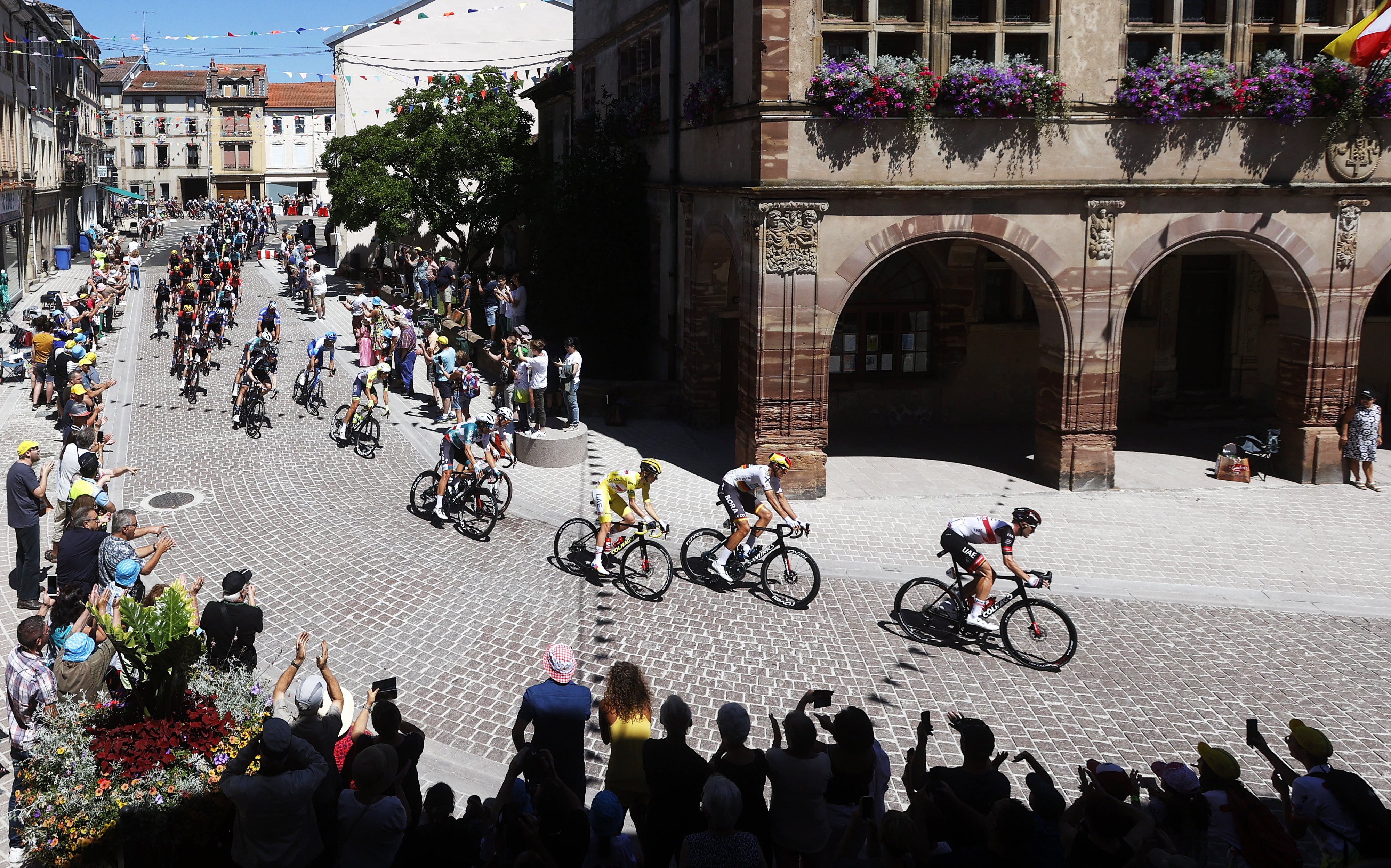 The peloton moves through the town of Rambervillers