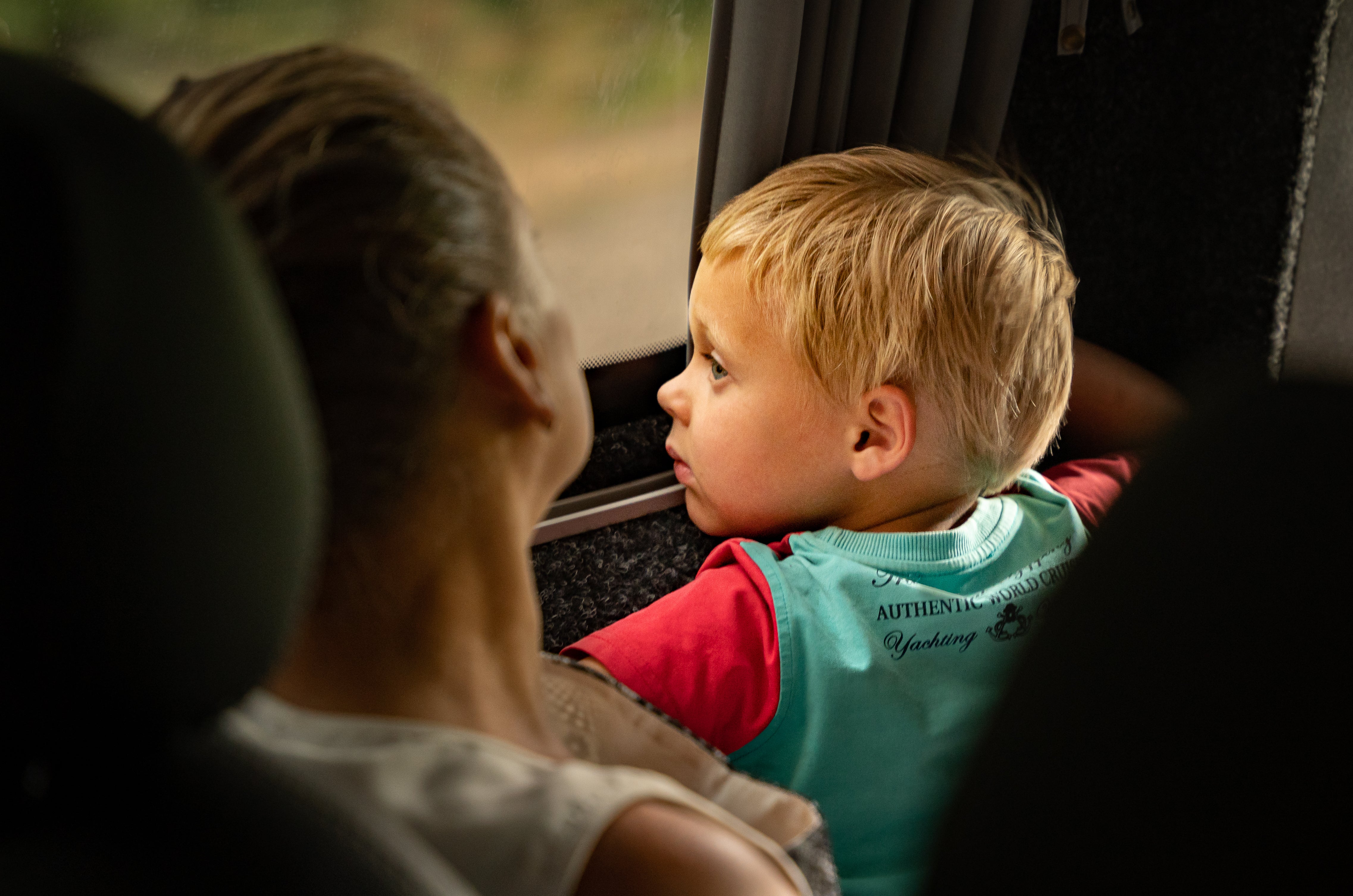 A toddler looks out the window of an evacuation bus The Independent joined bringing civilians out of frontline Donbas towns