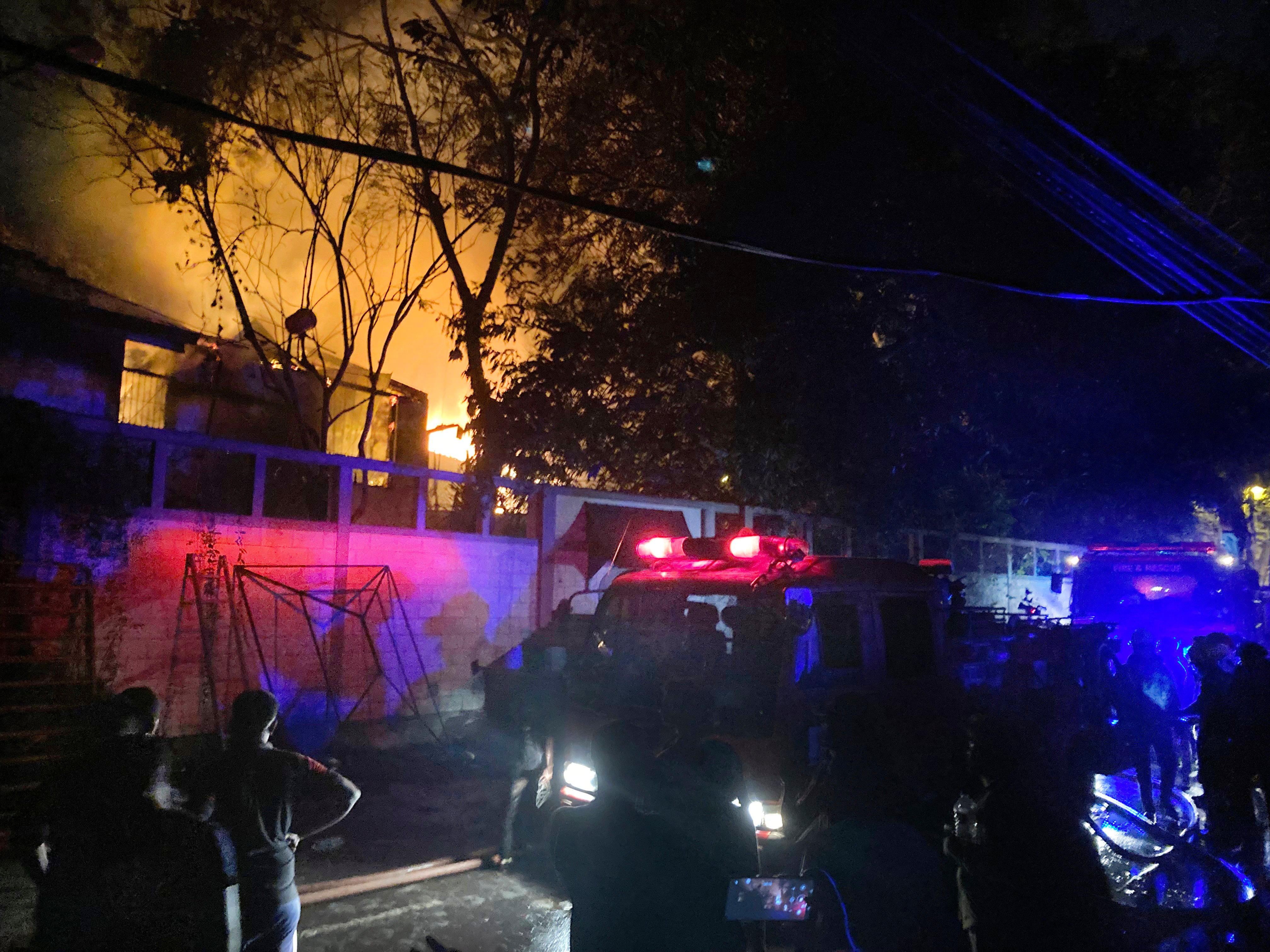 Firefighters try to douse a fire at the Sri Lankan prime minister Ranil Wickremesinghe's private residence