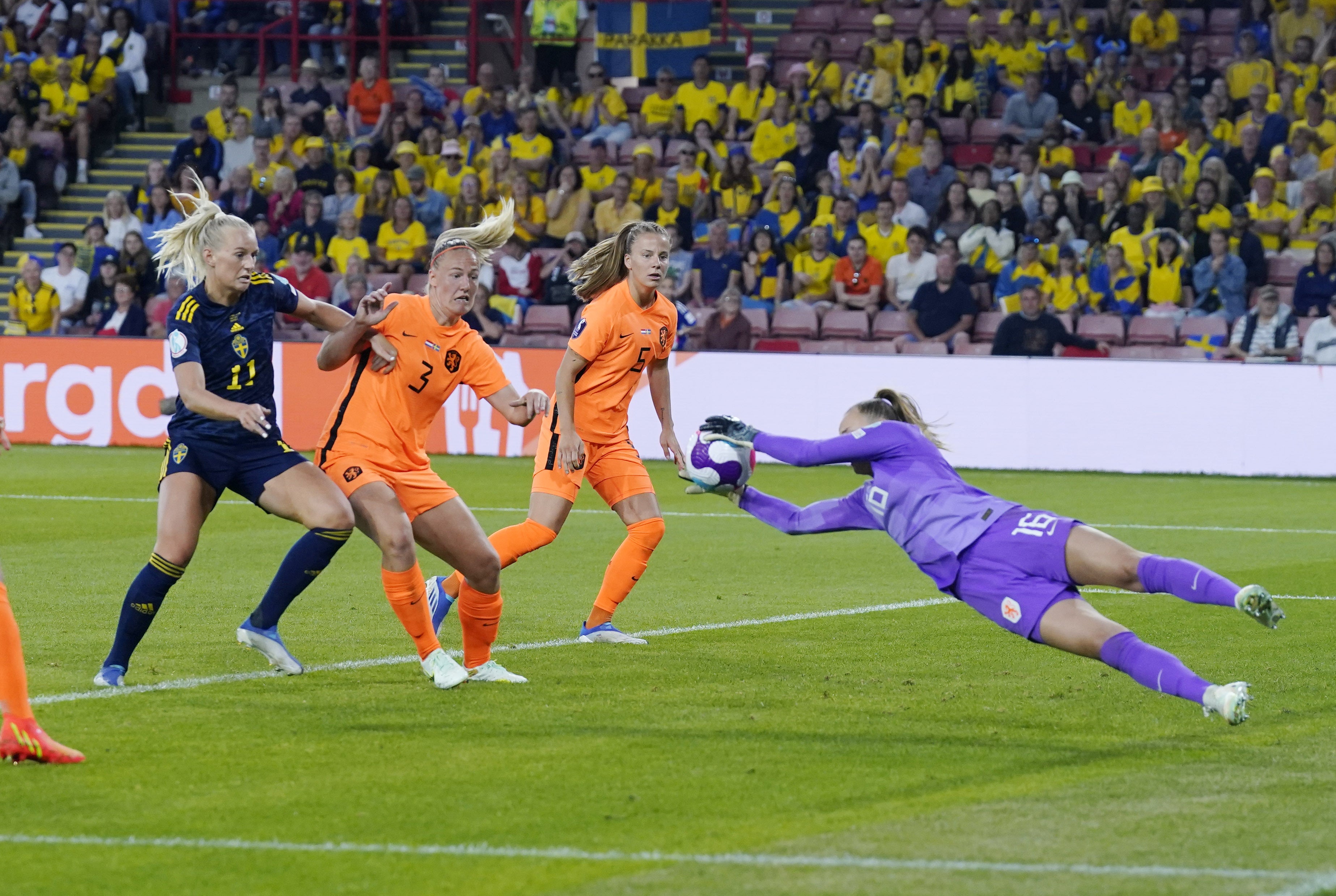 Daphne van Domselaar, right, dives to cut out Johanna Rytting Kaneryd’s cross (Danny Lawson/PA)