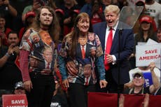 Bizarre moment Trump pulls fans on stage wearing shirts of his face and says ‘give ‘em to me right now’