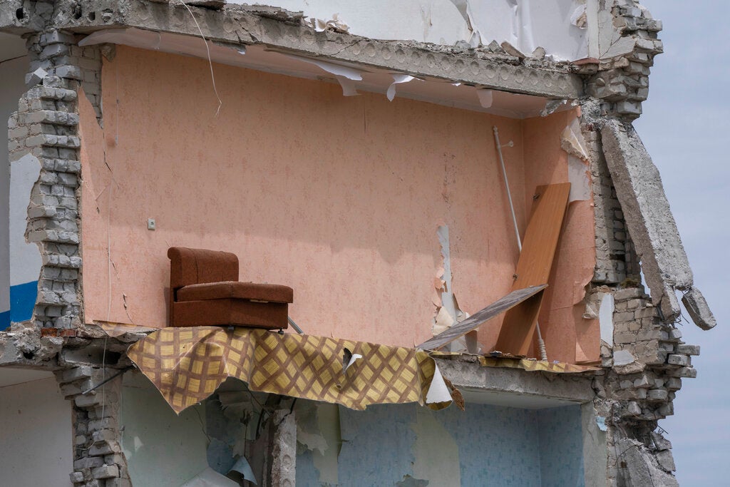 A sofa left standing in the aftermath of Russia’s attack on the apartment block