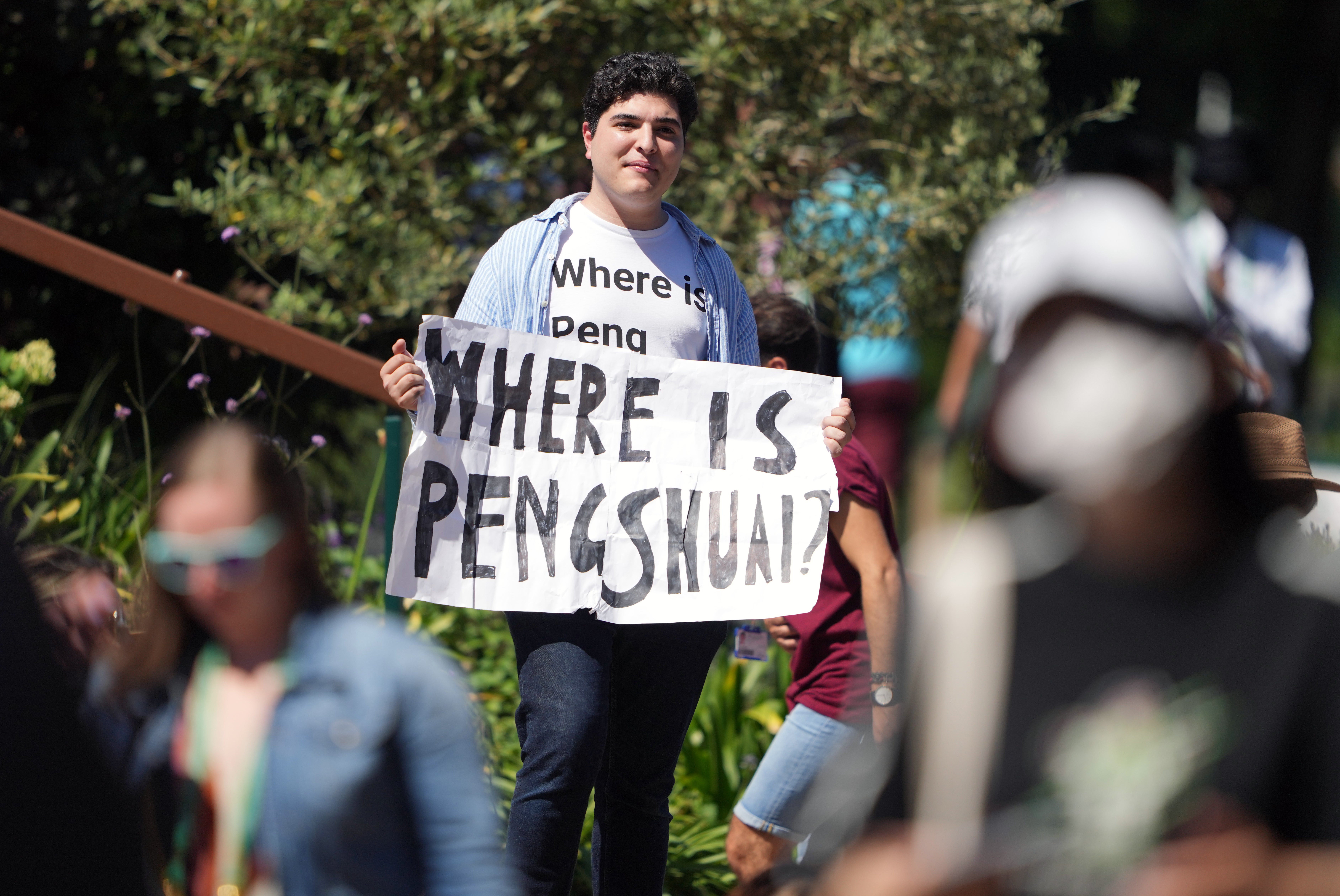 Drew Pavlou holding his sign on the hill in Wimbledon on Friday (PA)