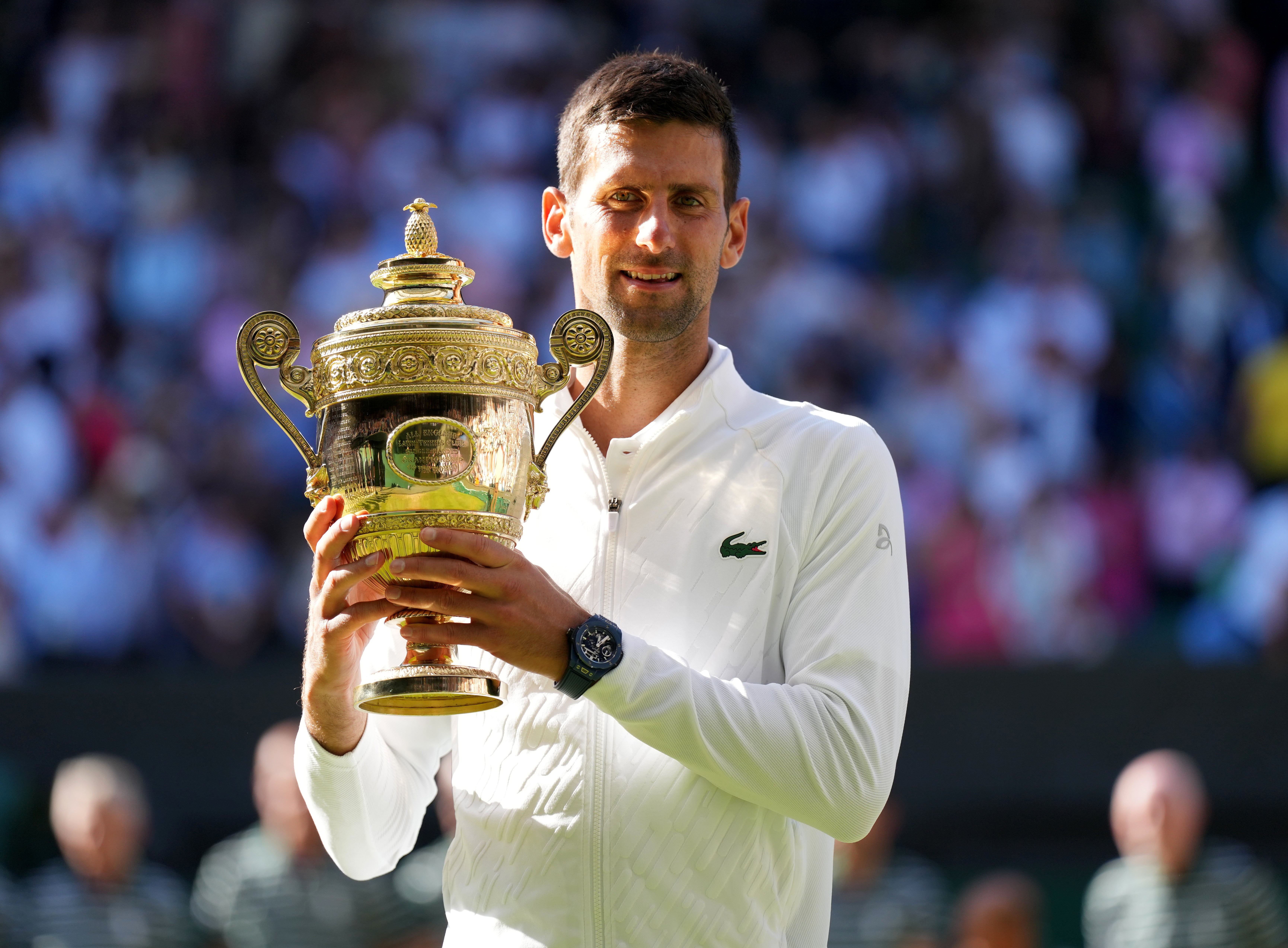 Novak Djokovic holds the Wimbledon trophy for the seventh time (Zac Goodwin/PA)