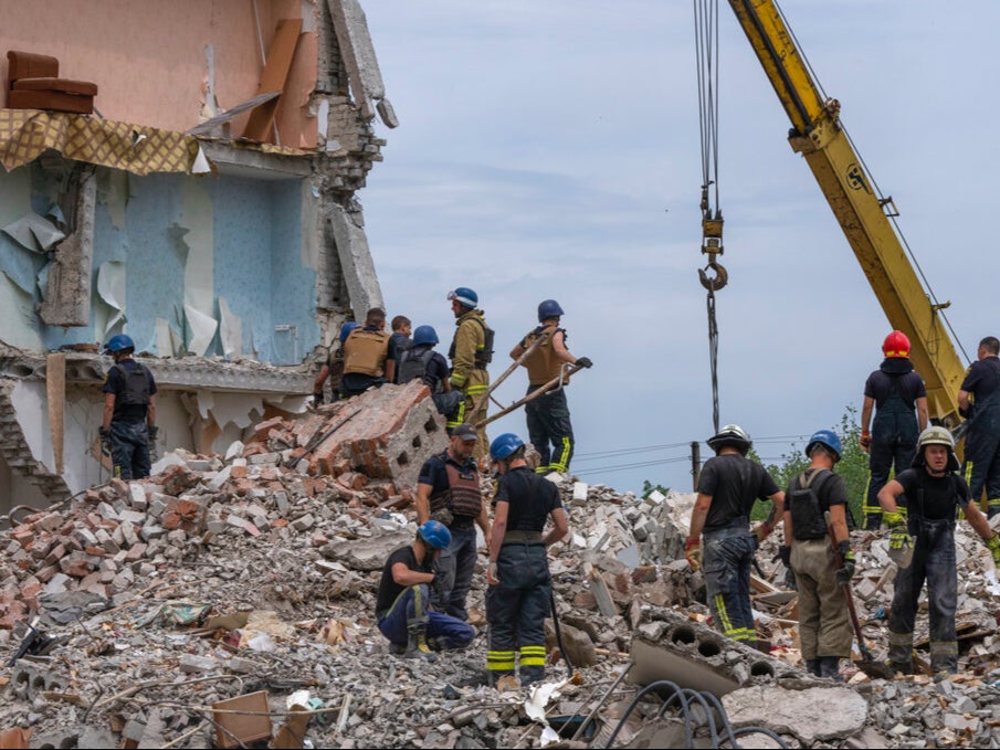 Rescue workers sift through the rubble to find people trapped under the ruins