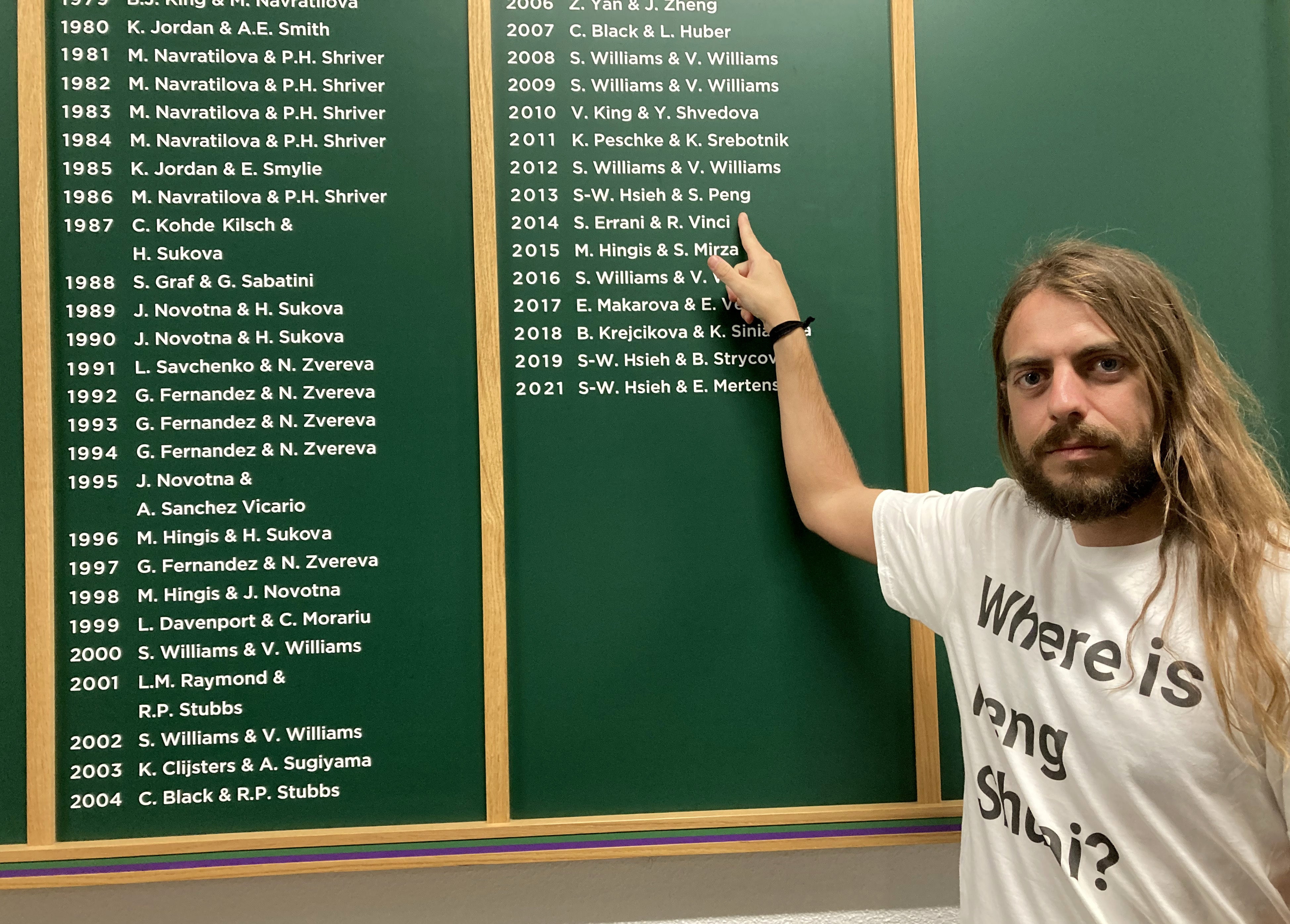 Protester Jason Leith points at the Wimbledon honours board to draw attention to the Peng Shuai situation (Rebecca Speare-Cole/PA)