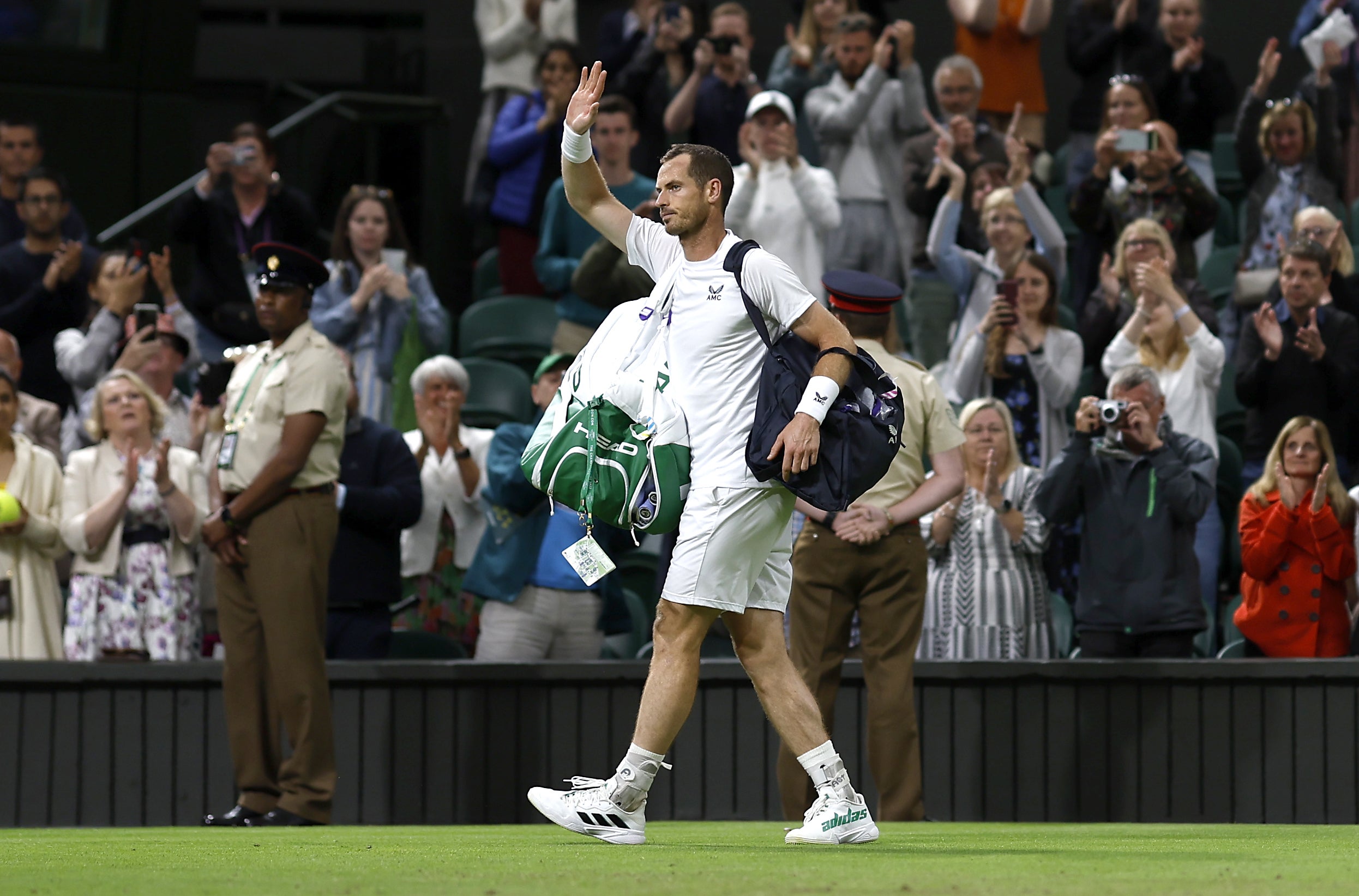 Andy Murray waves goodbye to Centre Court after a second-round exit to big-serving John Isner, on the same day Emma Raducanu was beaten (Steven Paston/PA)