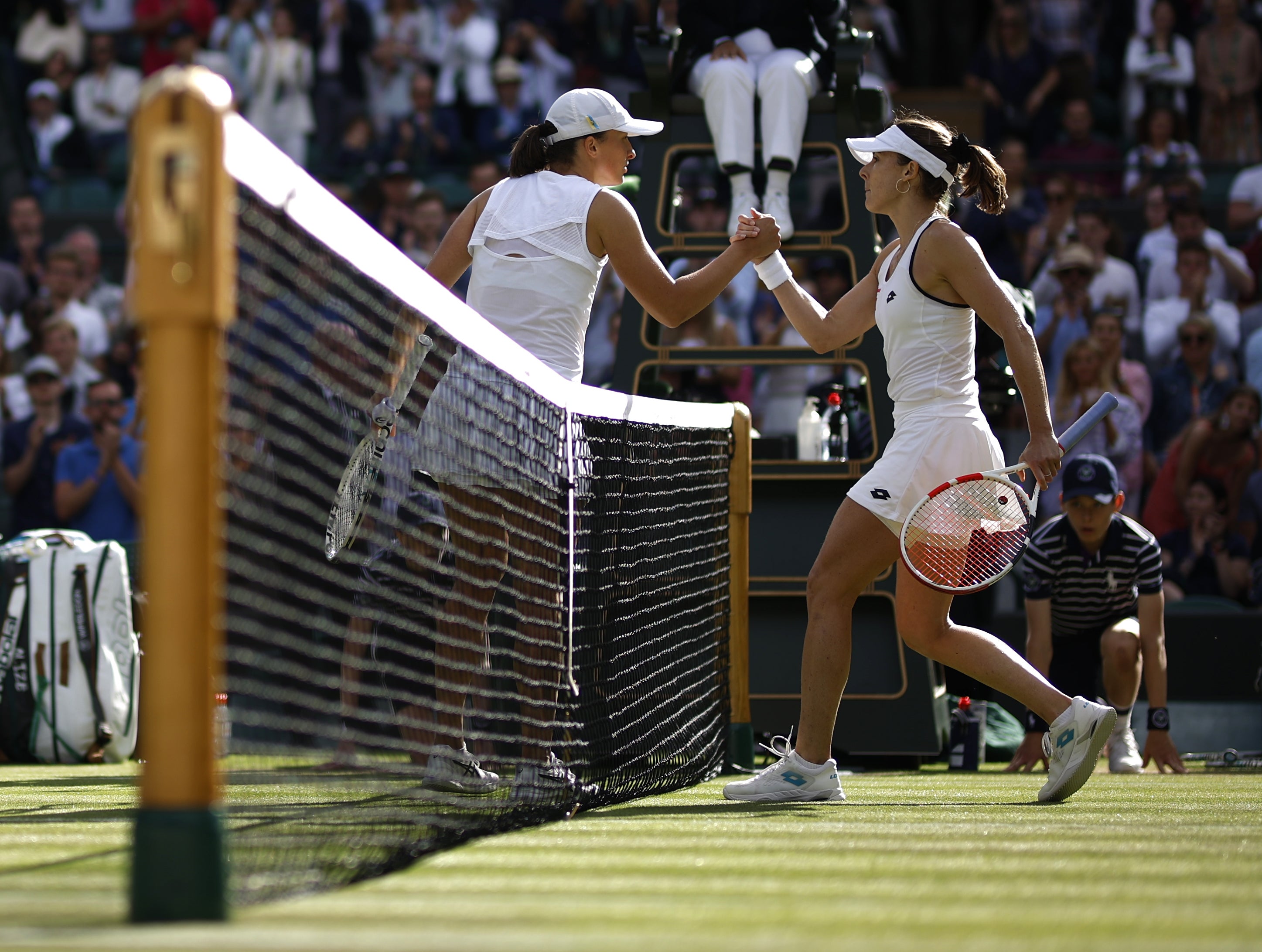 Top seed Iga Swiatek is knocked out by Alize Cornet, right (Steven Paston/PA)