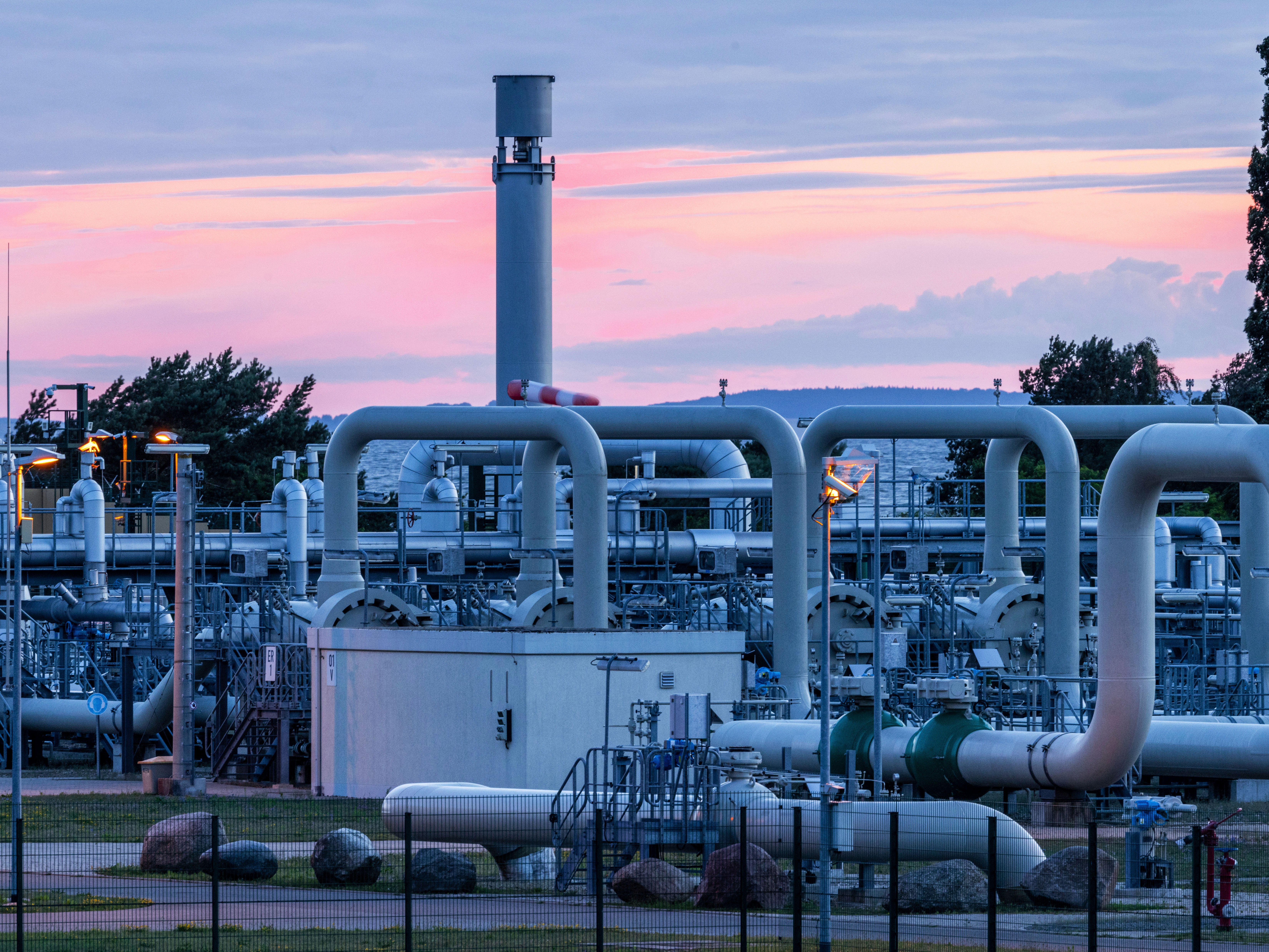 The sun rises behind the a Nord Stream 1 pipeline station in Lubmin, Germany on Monday