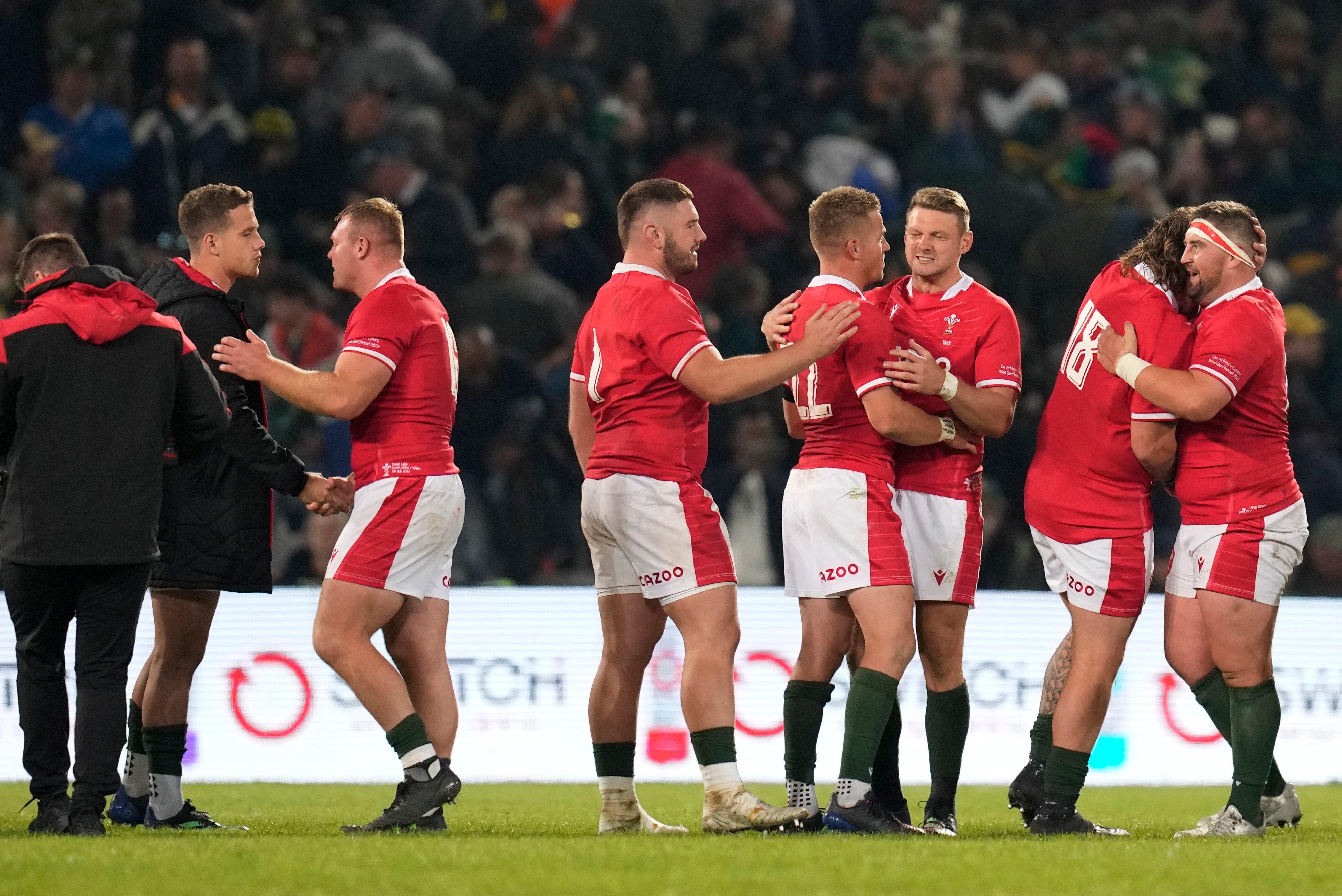 Wales players celebrate victory over South Africa in Bloemfontein (Themba Hadebe/AP)