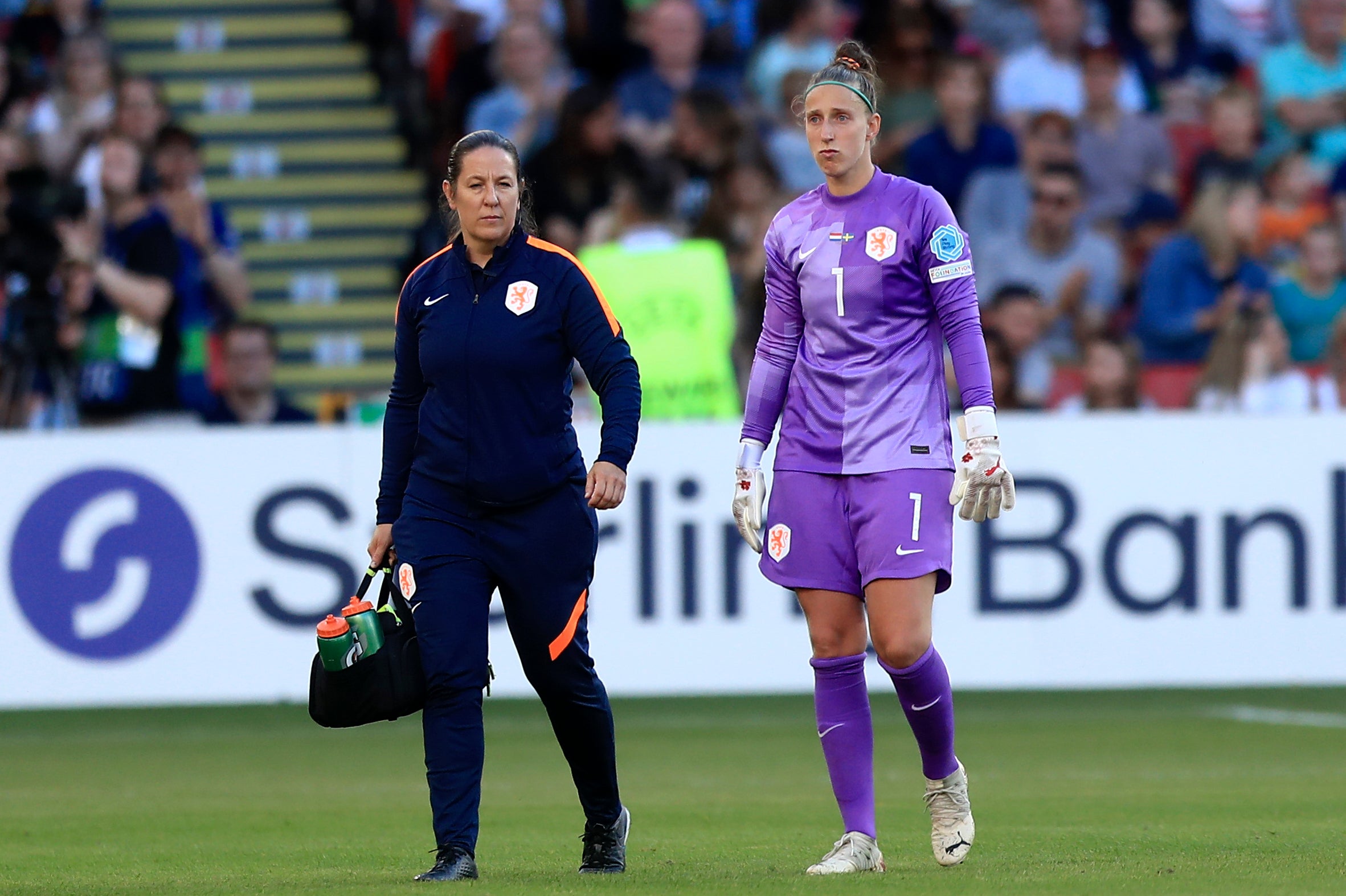 Sari van Veenendaal, right, leaves the pitch after her injury against Sweden (Leila Coker/AP)