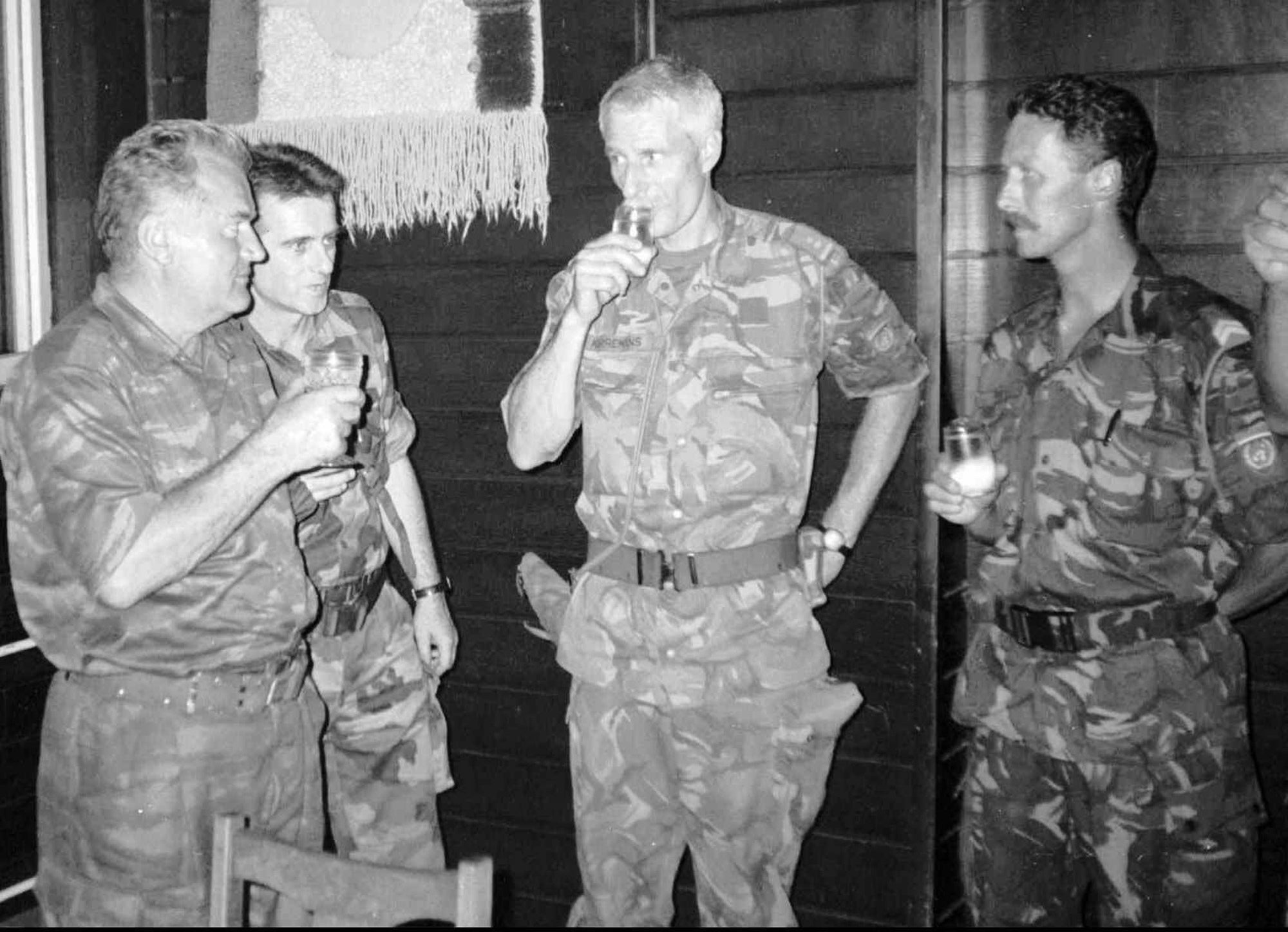 Bosnian Serb army commander General Ratko Mladic (left) drinks with Dutch UN commander Thom Karremans (second right) on 12 July 1995