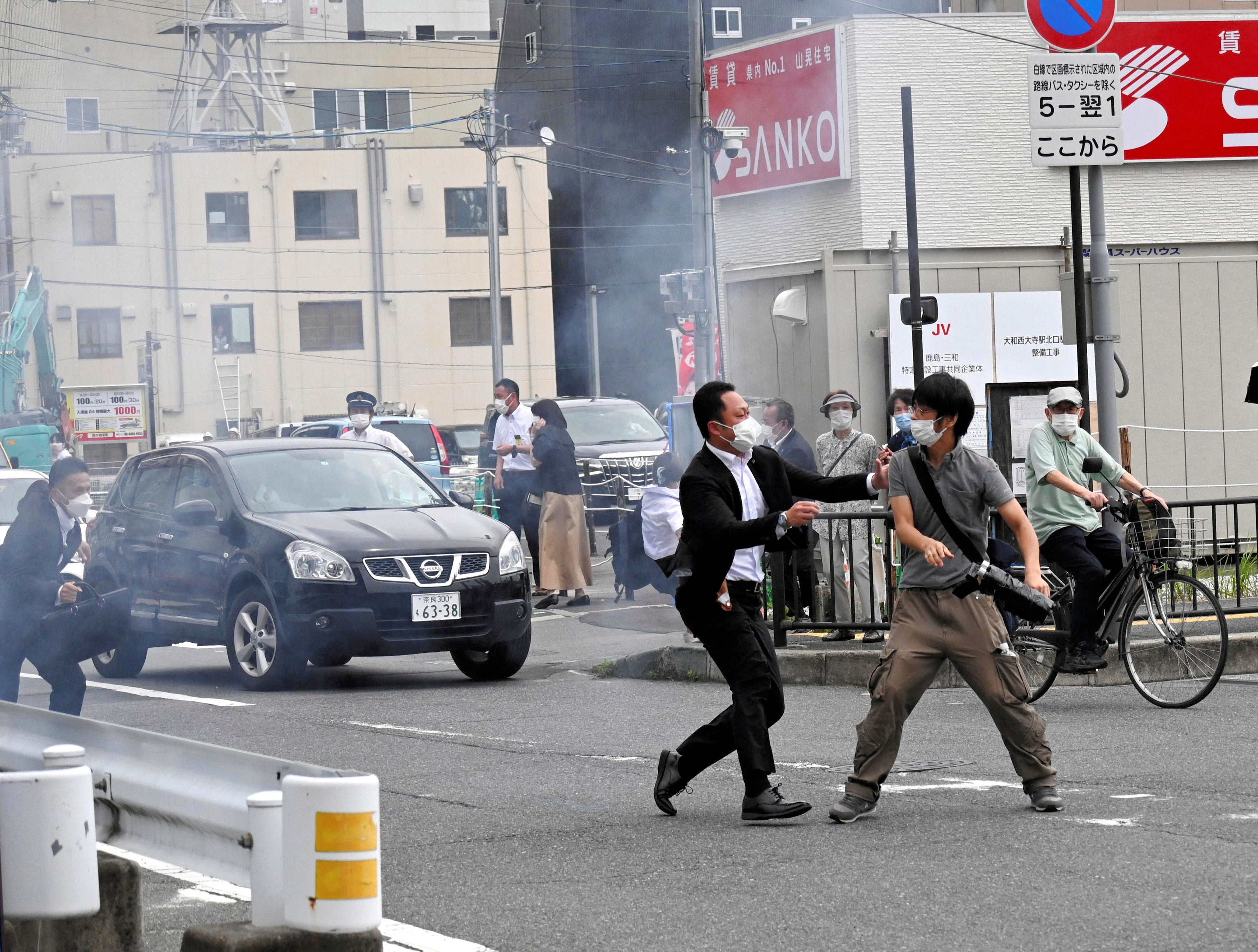A police officer detains a man, believed to have shot former Japanese prime minister Shinzo Abe, in Nara, western Japan on 8 July 2022