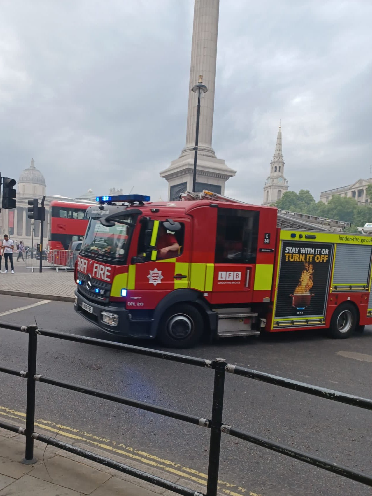 Fire engine passes Nelson’s Column in Trafalgar Square