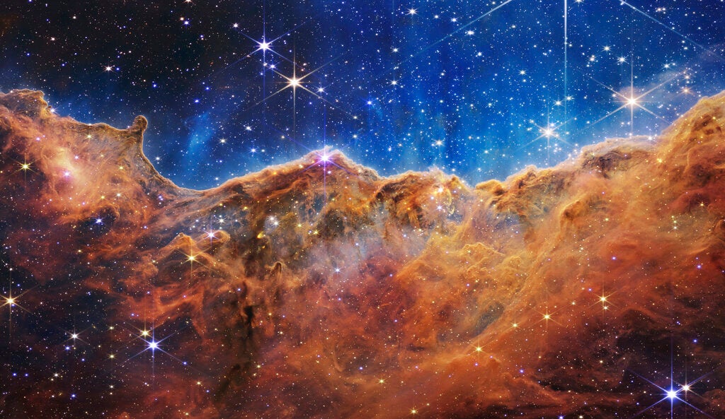 This image released by NASA on Tuesday, July 12, 2022, shows the edge of a nearby, young, star-forming region NGC 3324 in the Carina Nebula.