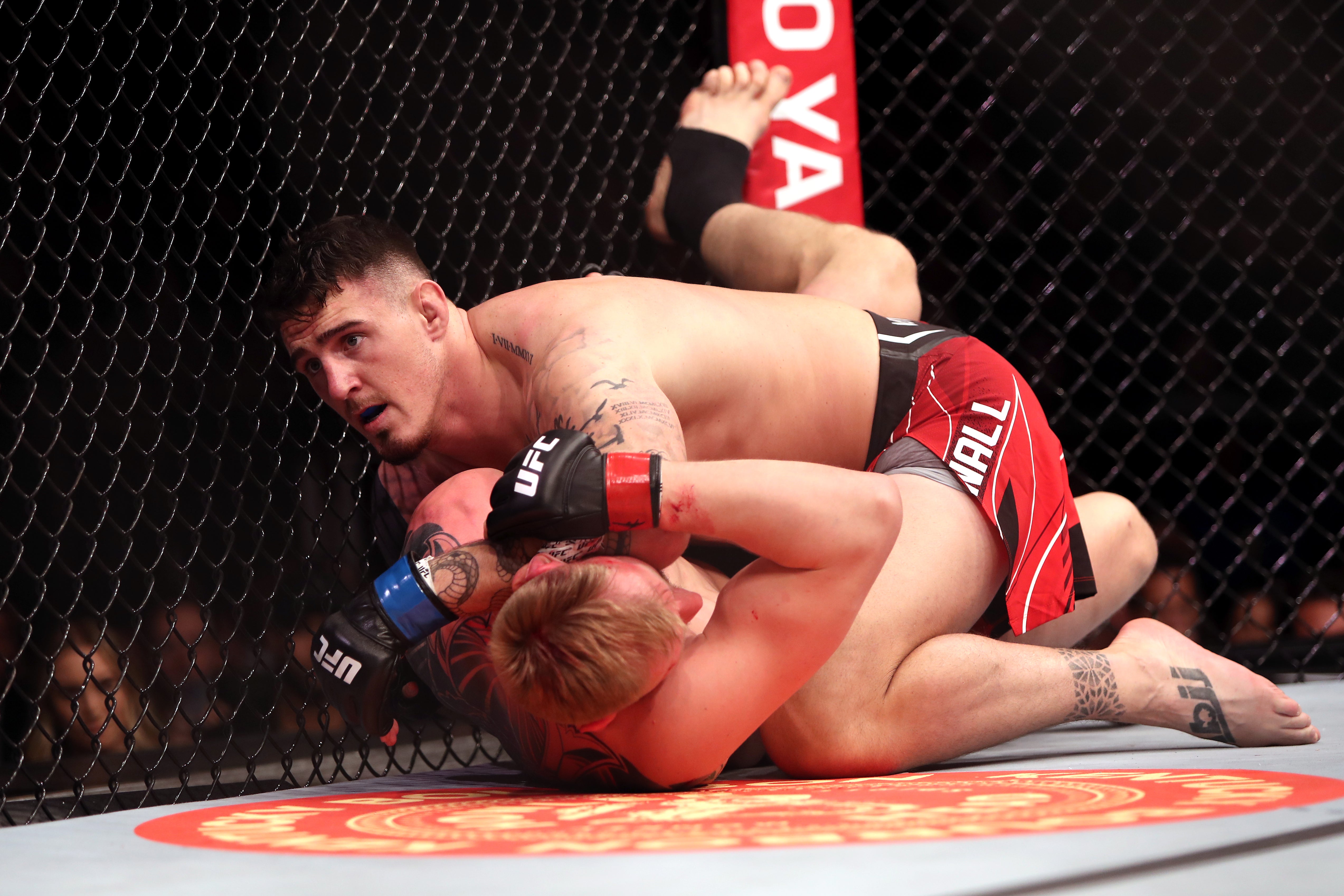 Tom Aspinall (top) submitted Alexander Volkov in March before suffering an unfortunate injury in July (Kieran Cleeves/PA)