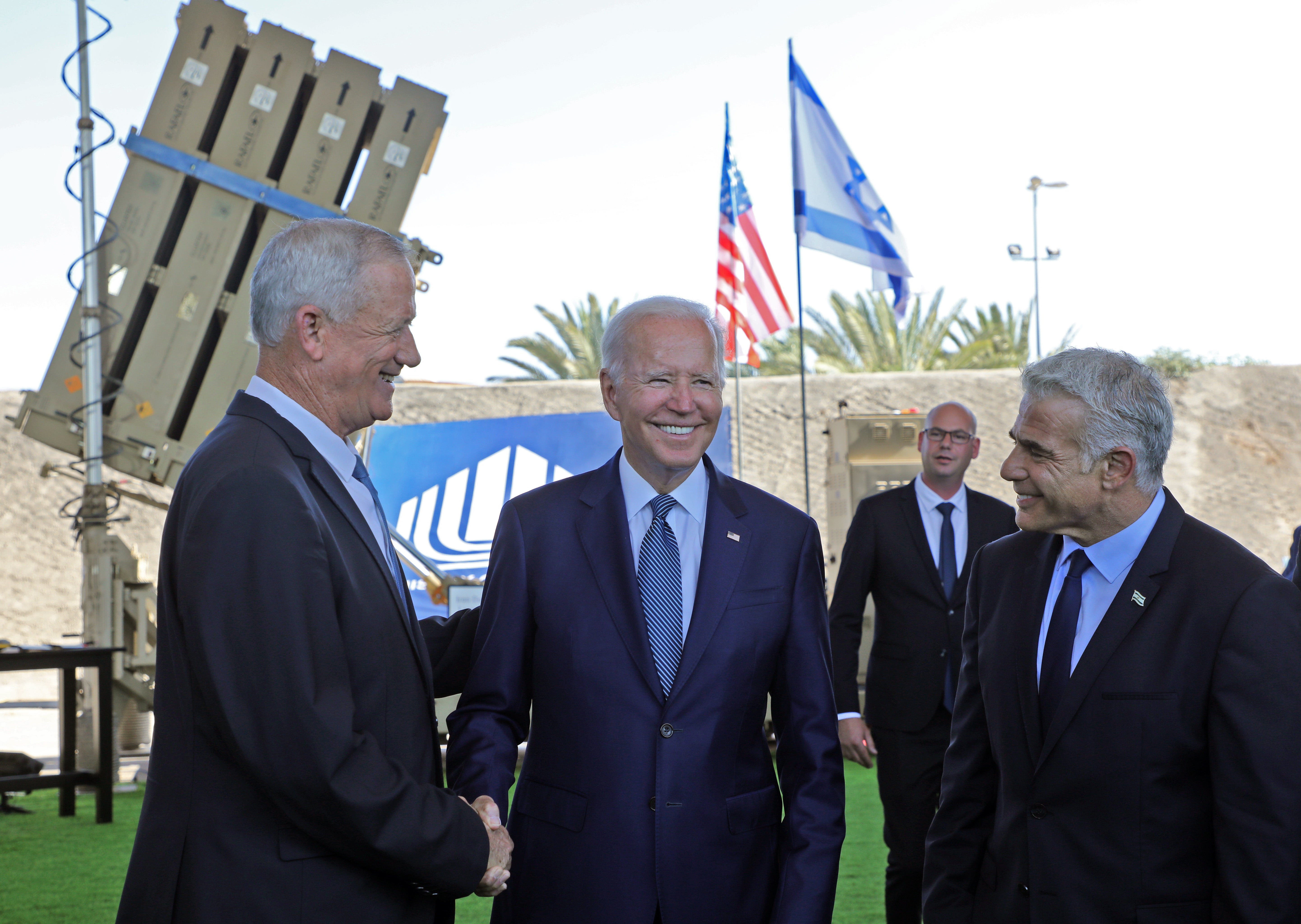 President Joe Biden and Israeli caretaker Prime Minister Yair Lapid, stand in front of Israel's Iron Dome defence system during a tour at Ben Gurion Airport