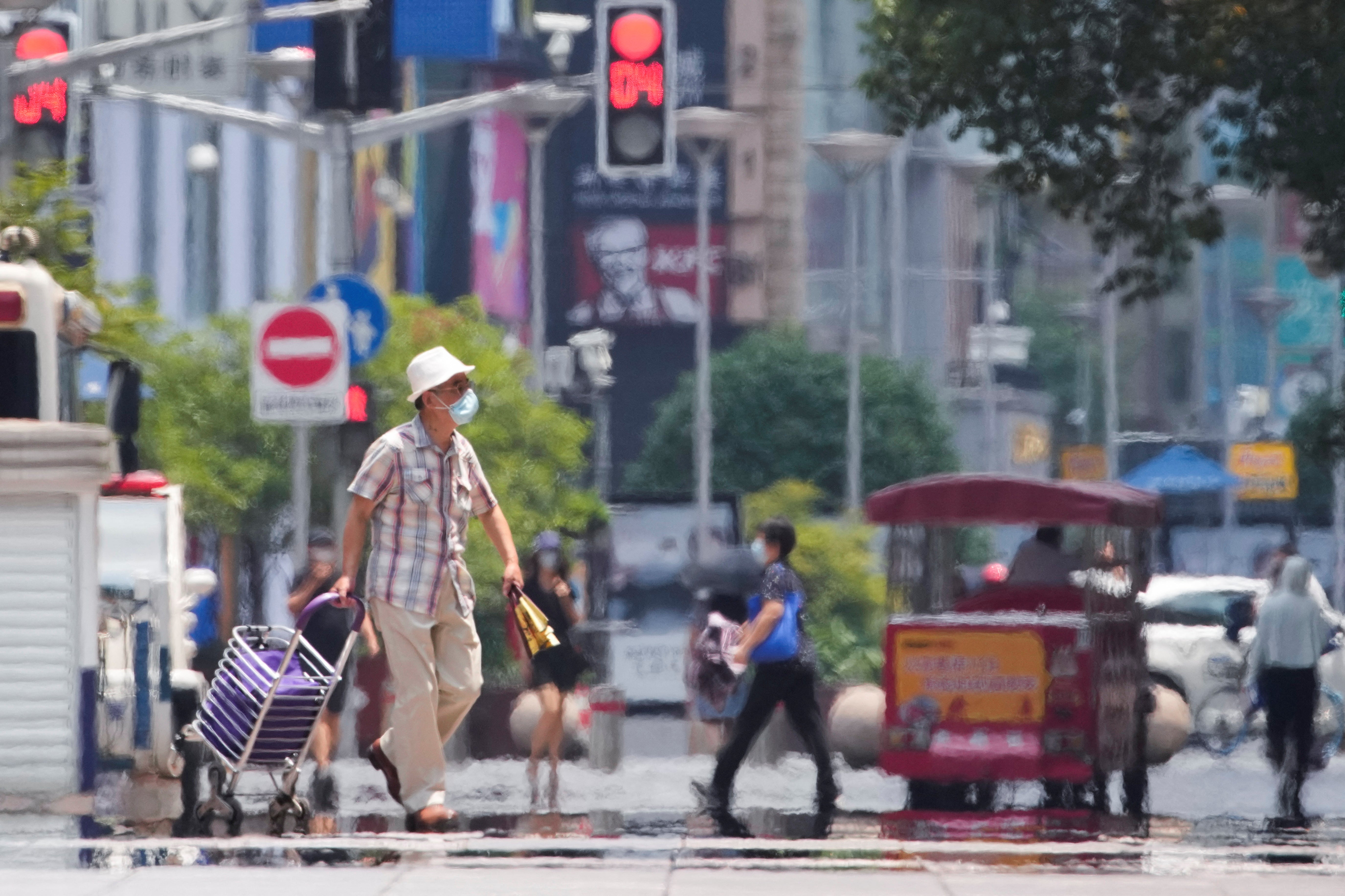 Pedestrians during a heatwave in Shanghai in July