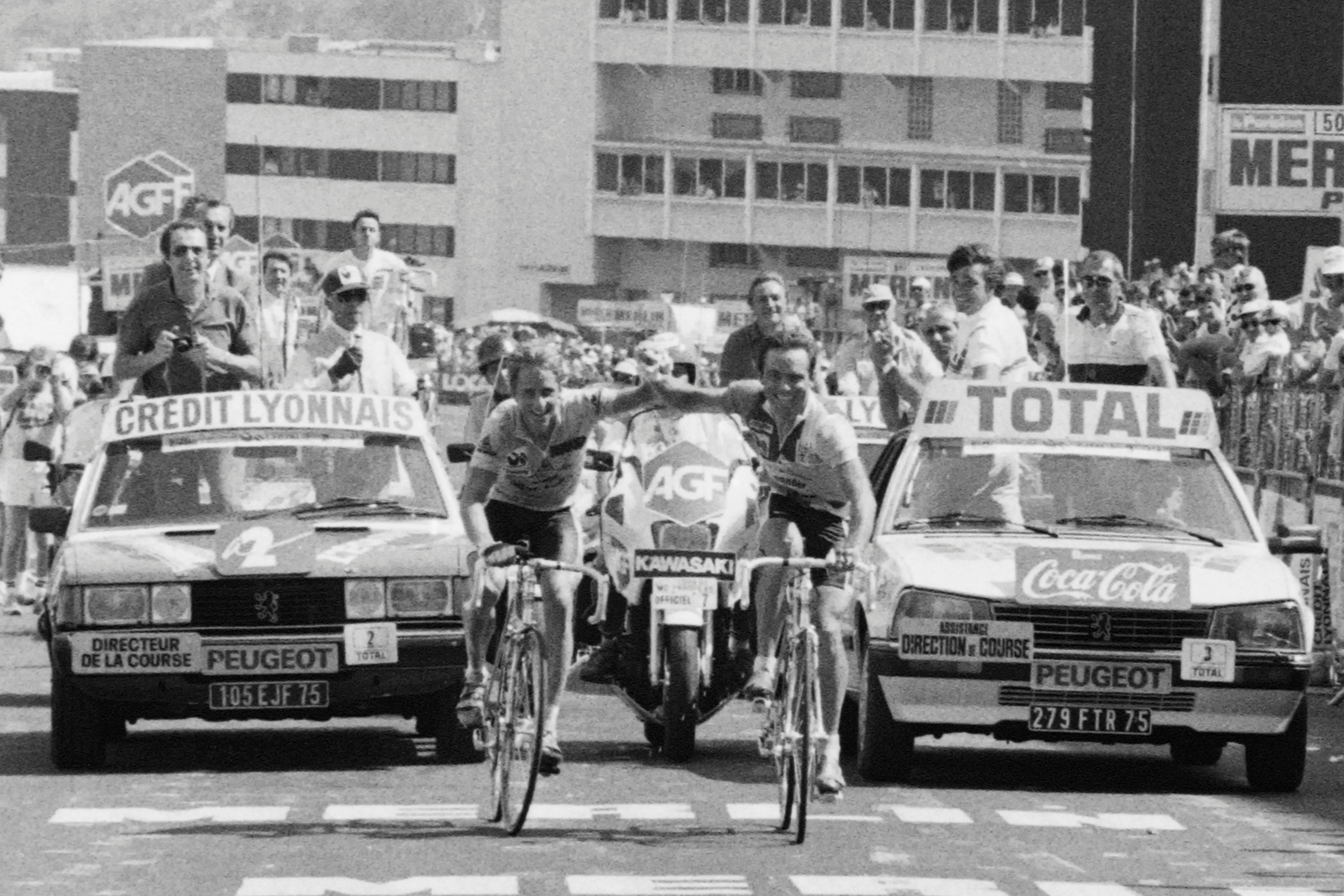 American Greg Lemond, left, and French teammate Bernard Hinault cross the line