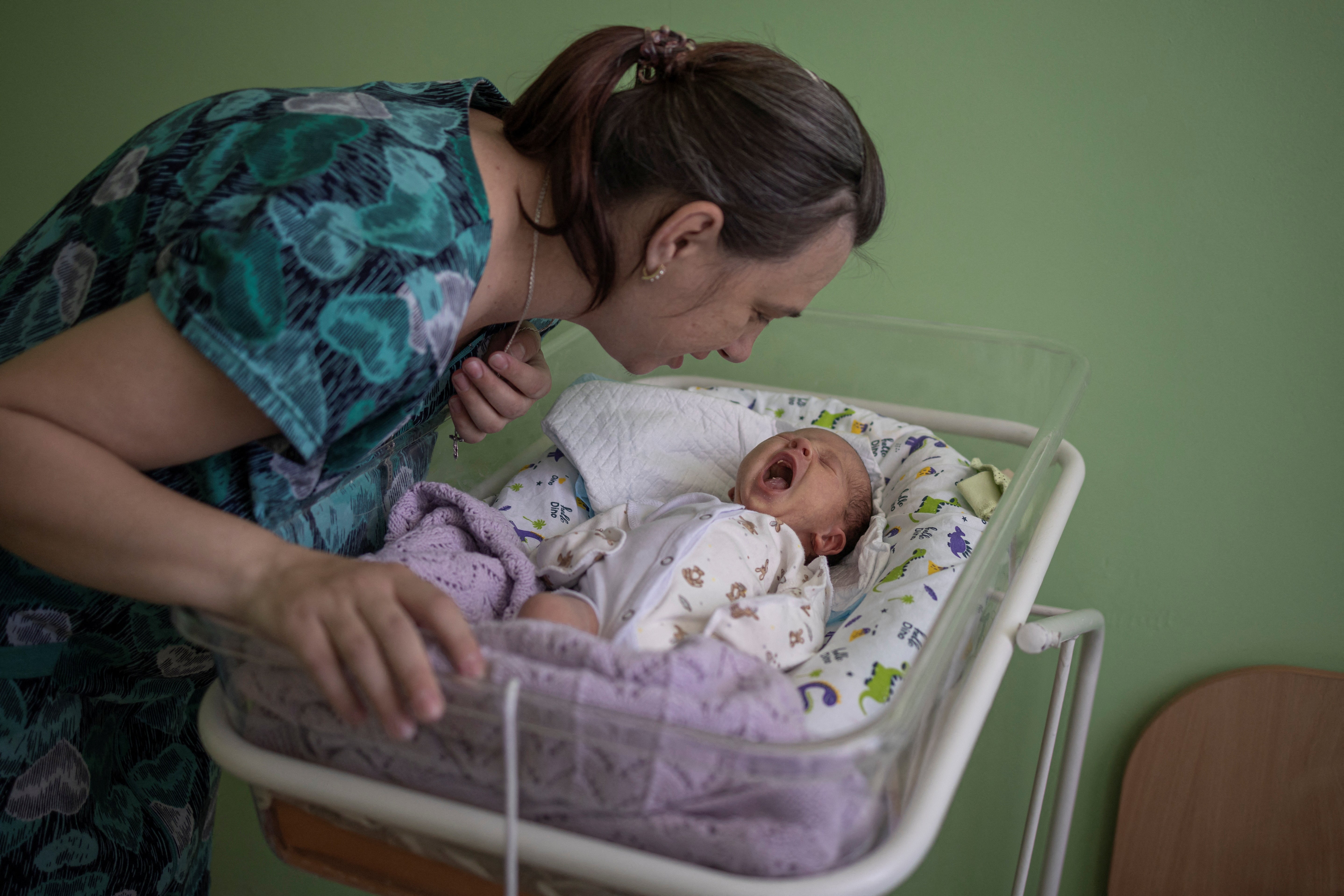 Elena checks on her baby, Mikhail