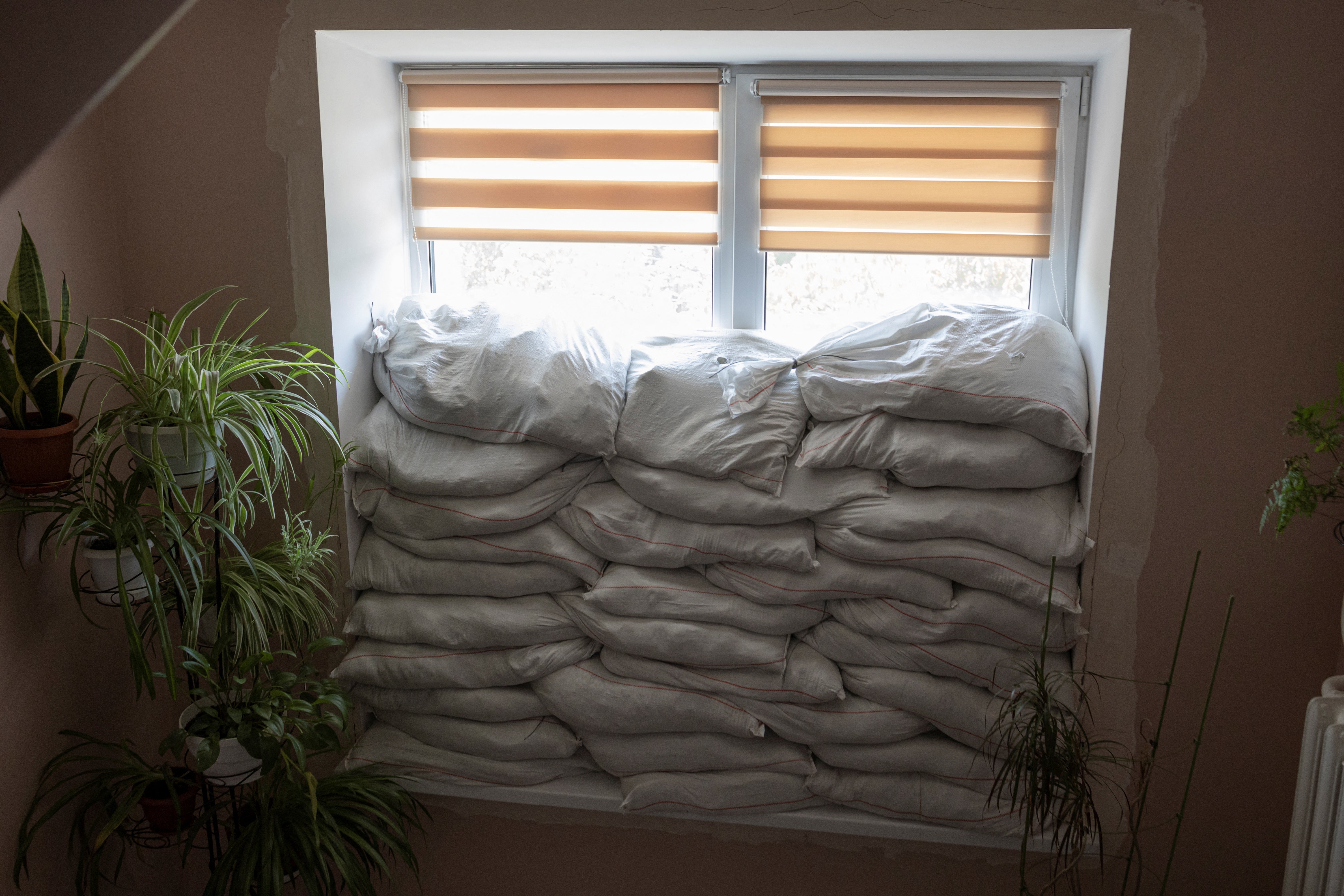 Sandbags piled in front of a window