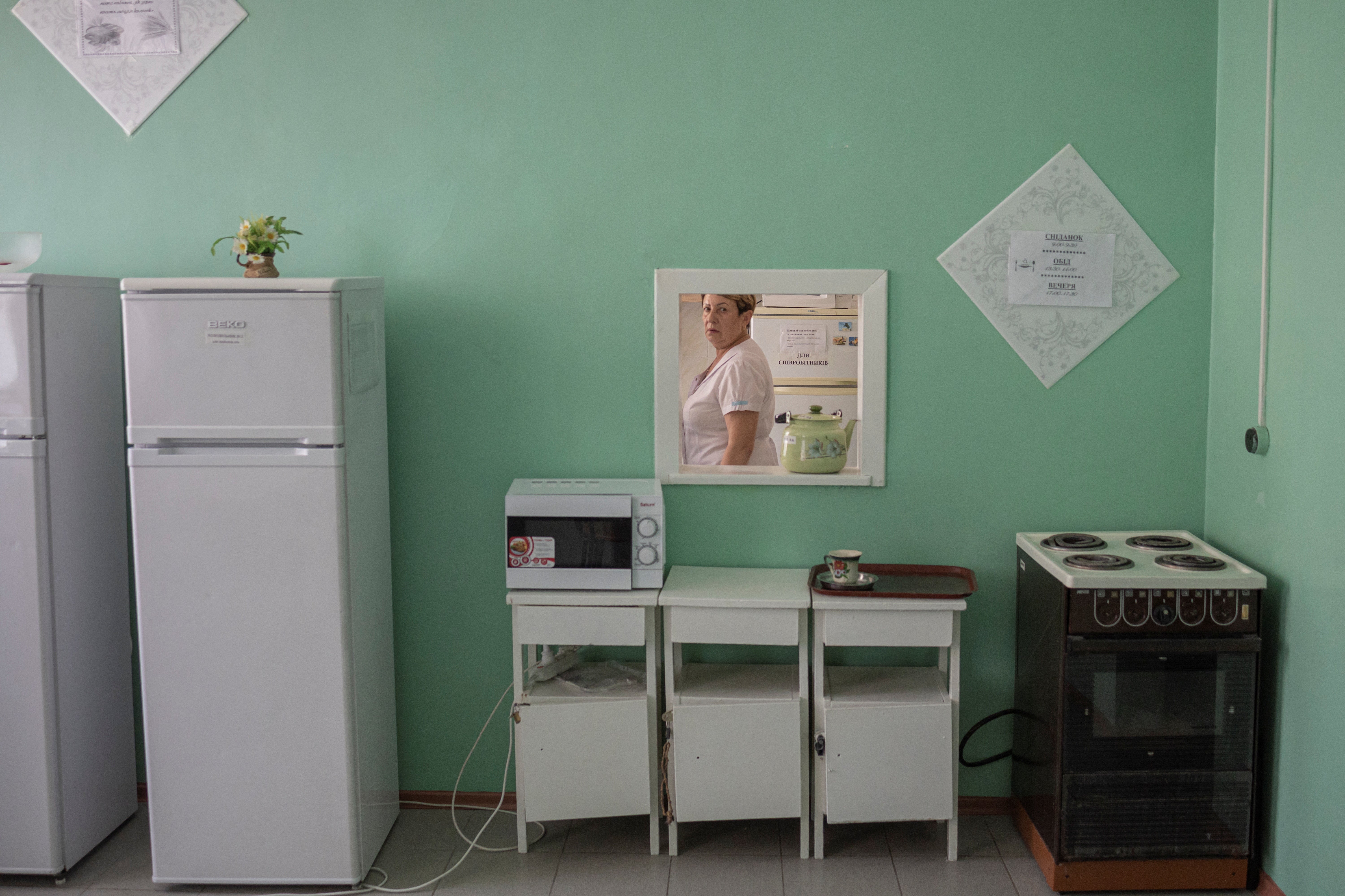 A nurse walks in a kitchen at the maternity hospital