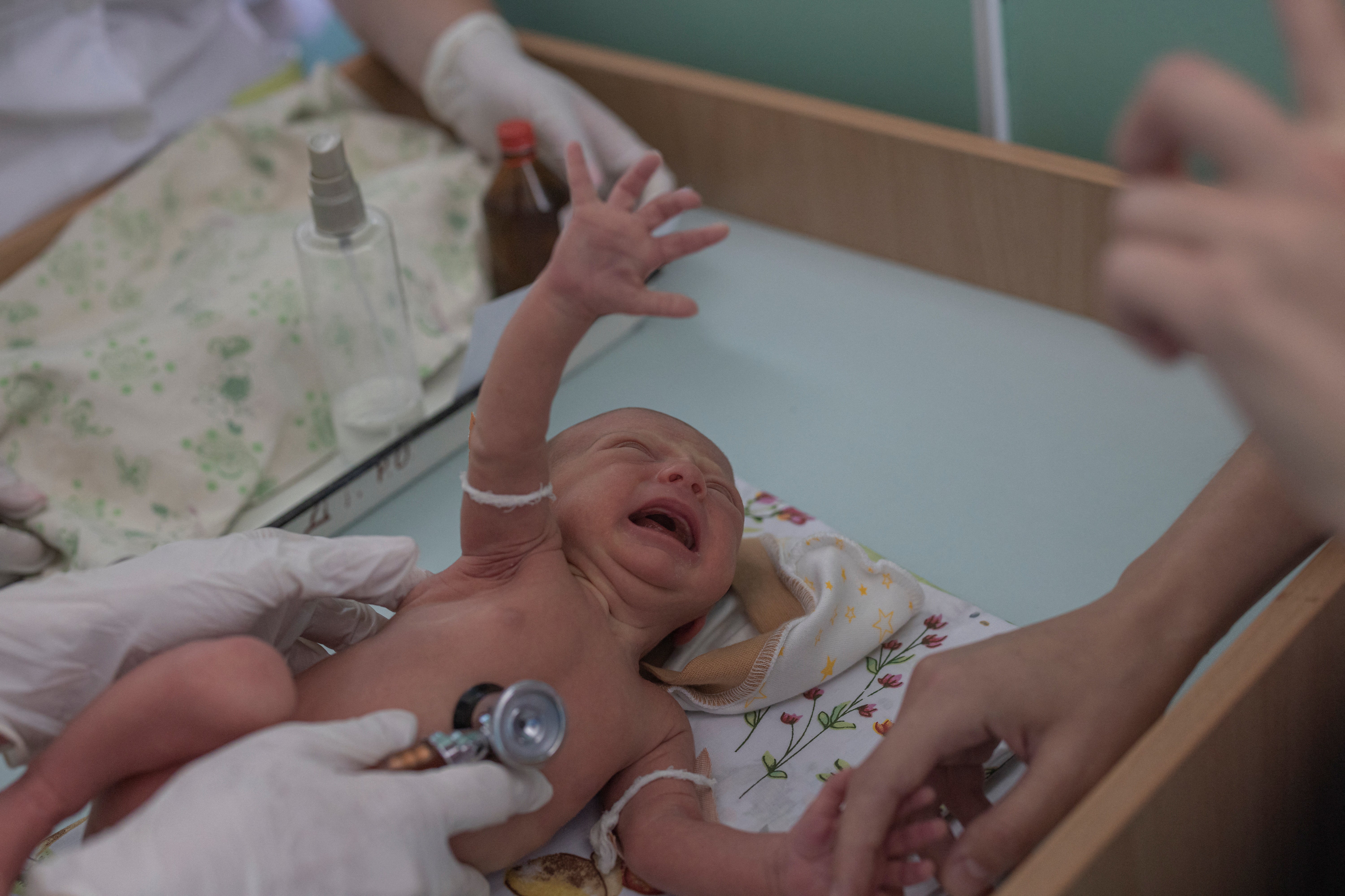 Marina Tupata watches as her six-day-old baby, Sofia, is examined