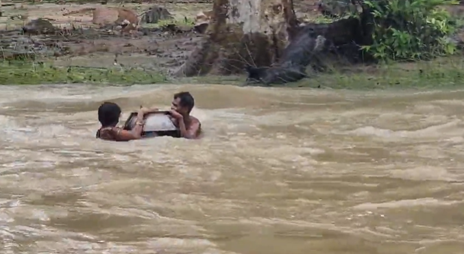 The video shows the family of three sailing away downstream, with the pot acting as vessel and float