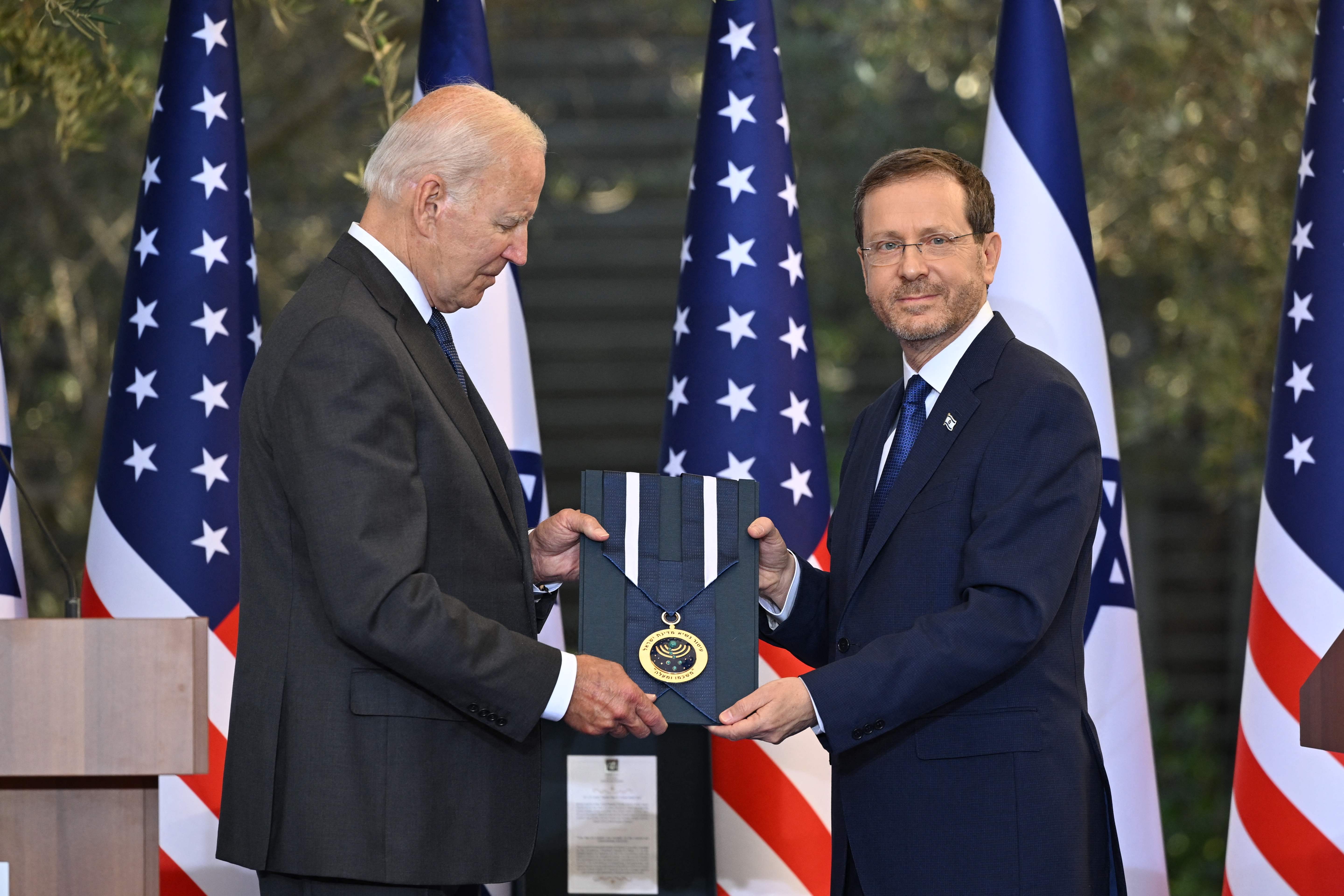 Israeli President Isaac Herzog presents US President Joe Biden with the Presidential Medal of Honor