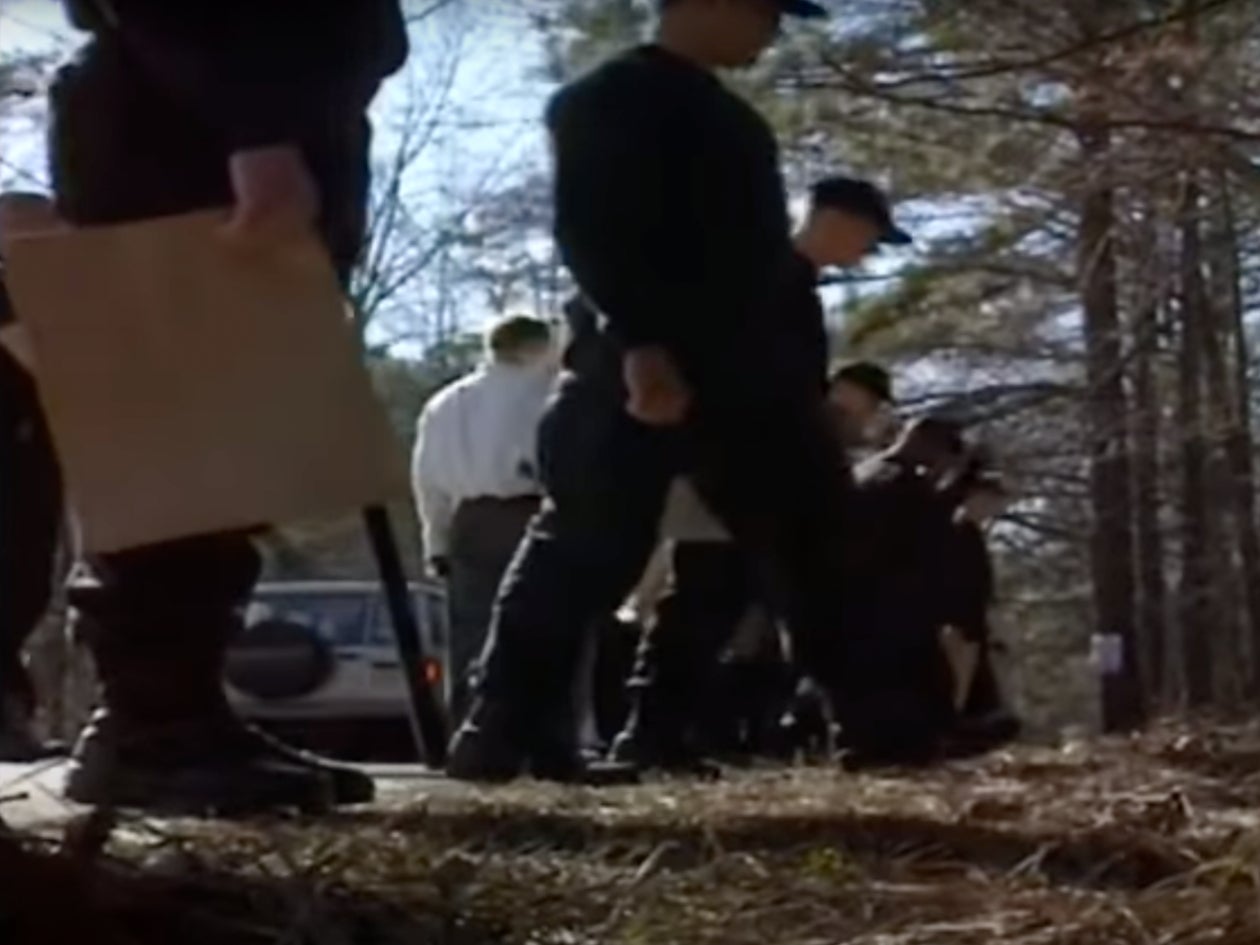 The child was found in a wooded area near a cemetery in 1999