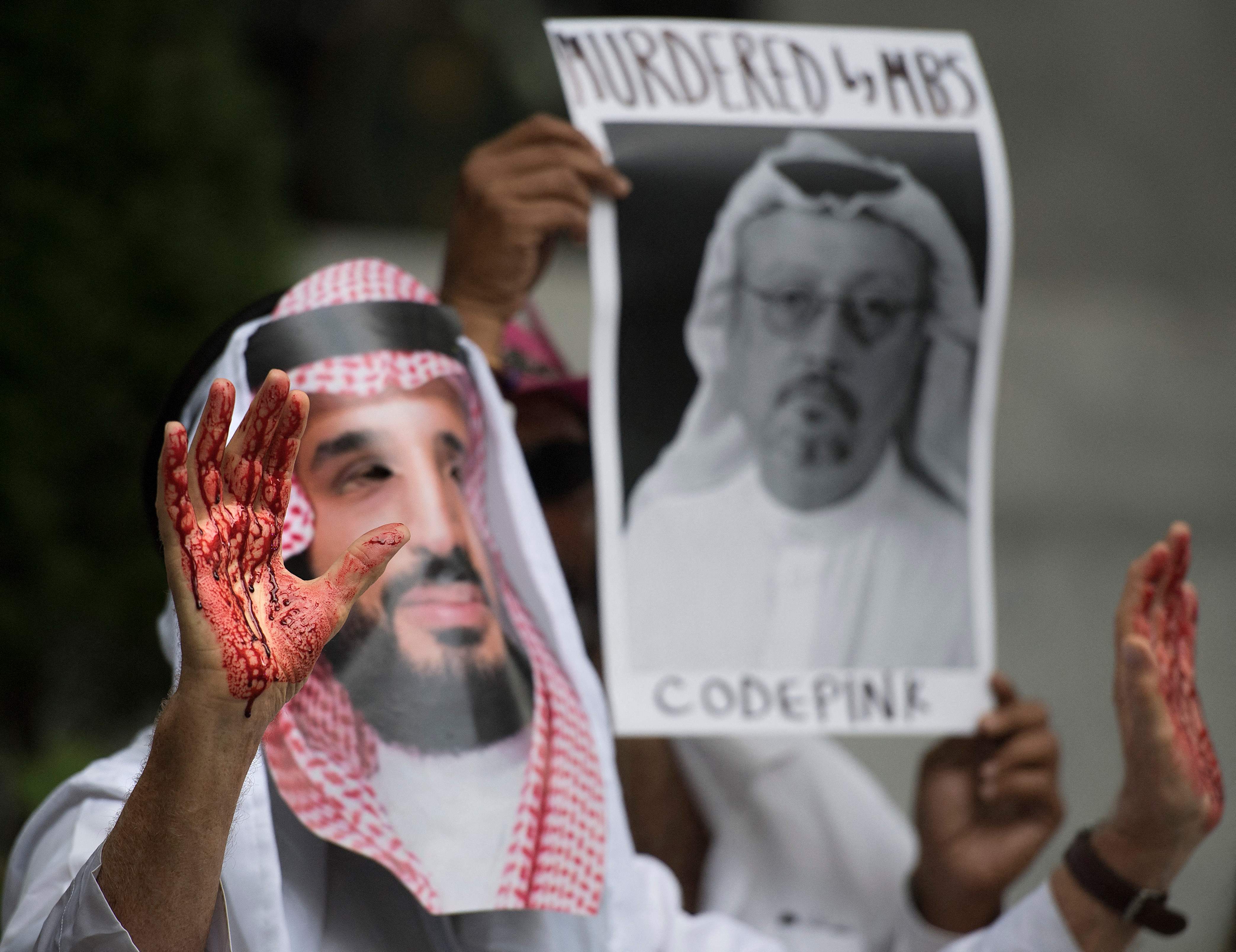 In this file photo taken on 10 October 2018, a demonstrator dressed as Saudi Arabian crown prince Mohammed bin Salman with blood on his hands protests outside the Saudi Embassy in Washington, DC, demanding justice for missing Saudi journalist Jamal Khashoggi