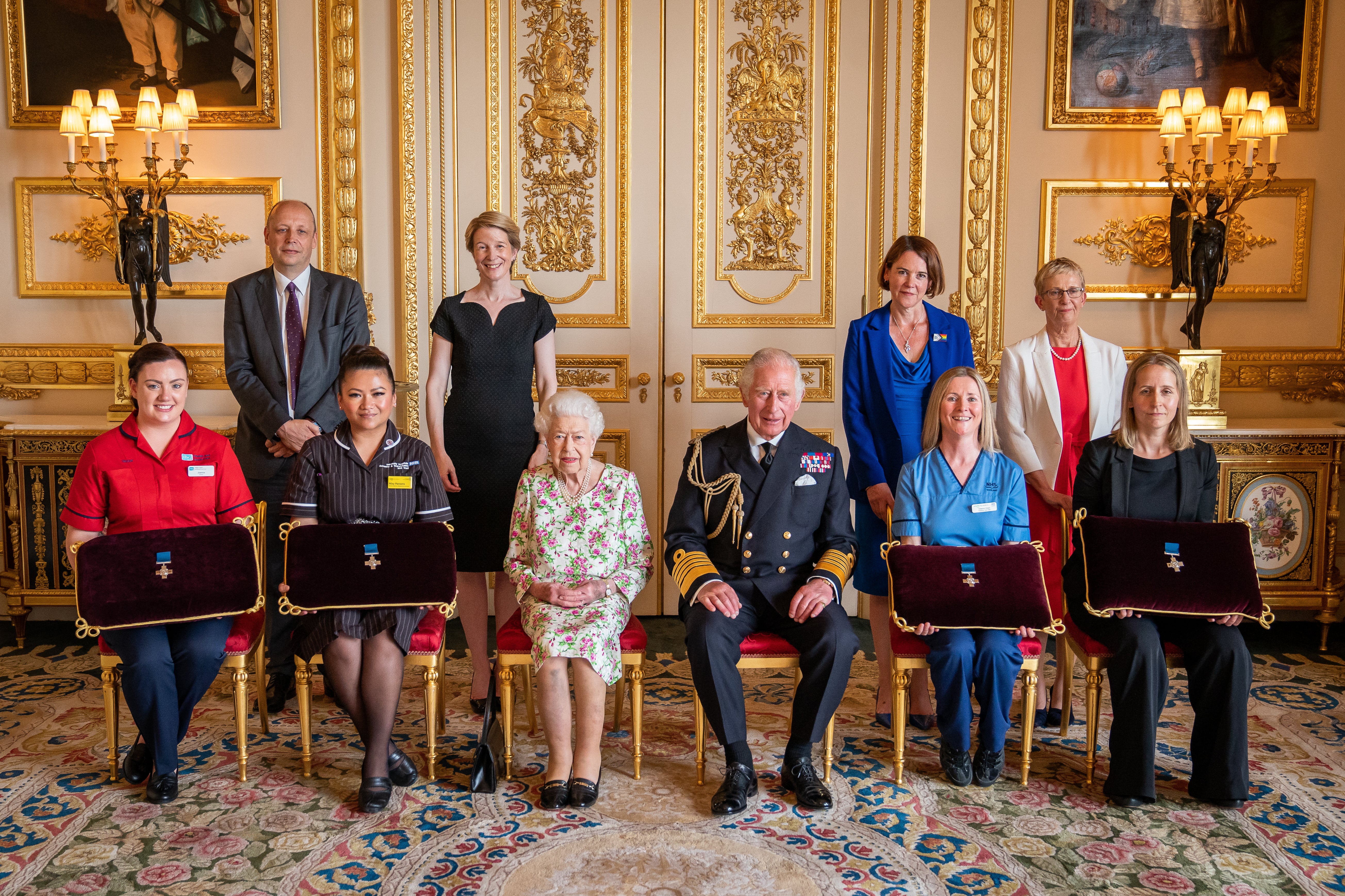 The Queen and Charles at the George Cross presentation with health representatives (PA)