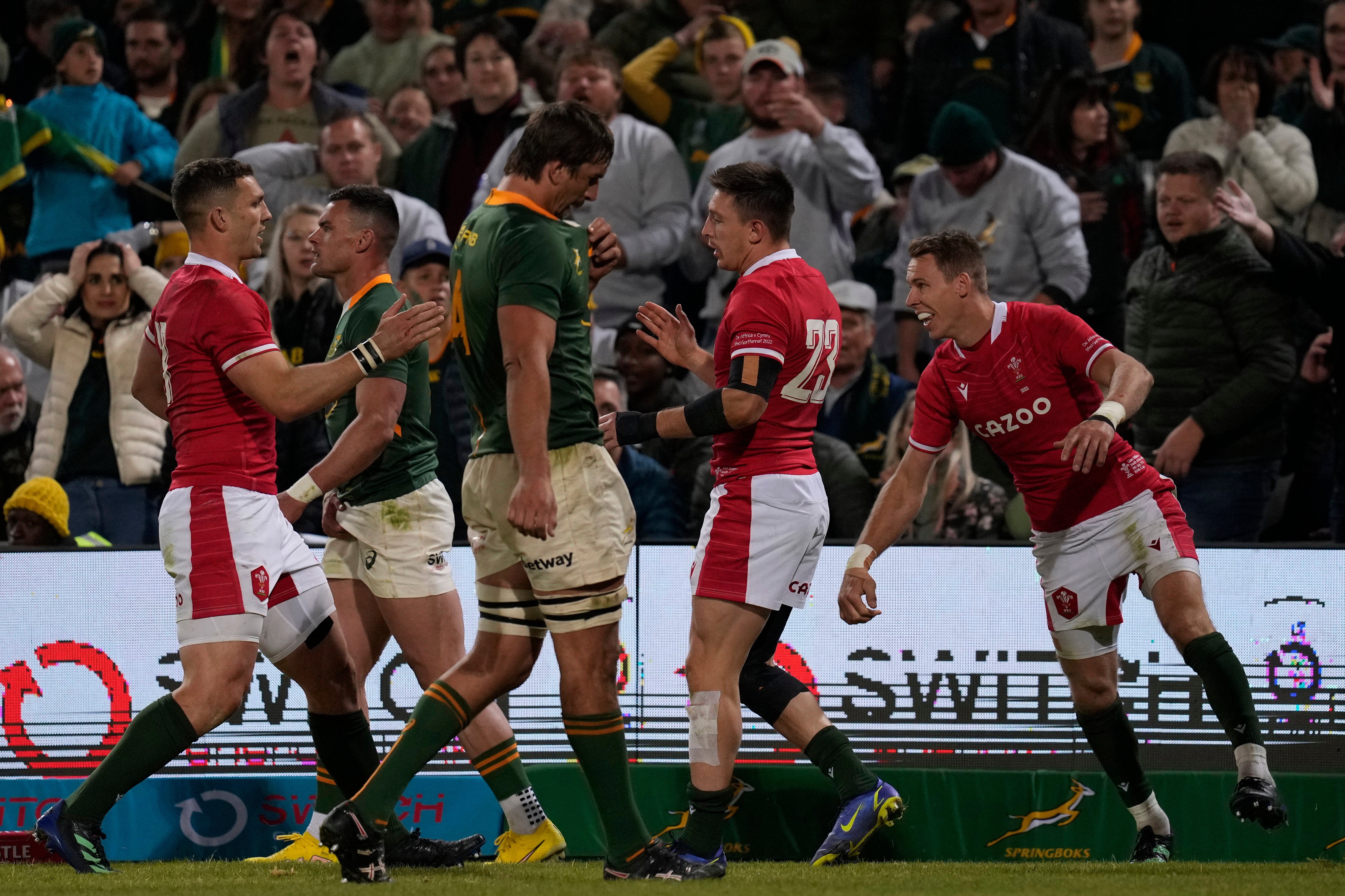 Wales players celebrate Josh Adams’ try in the second Test against South Africa (Themba Hadebe/AP)