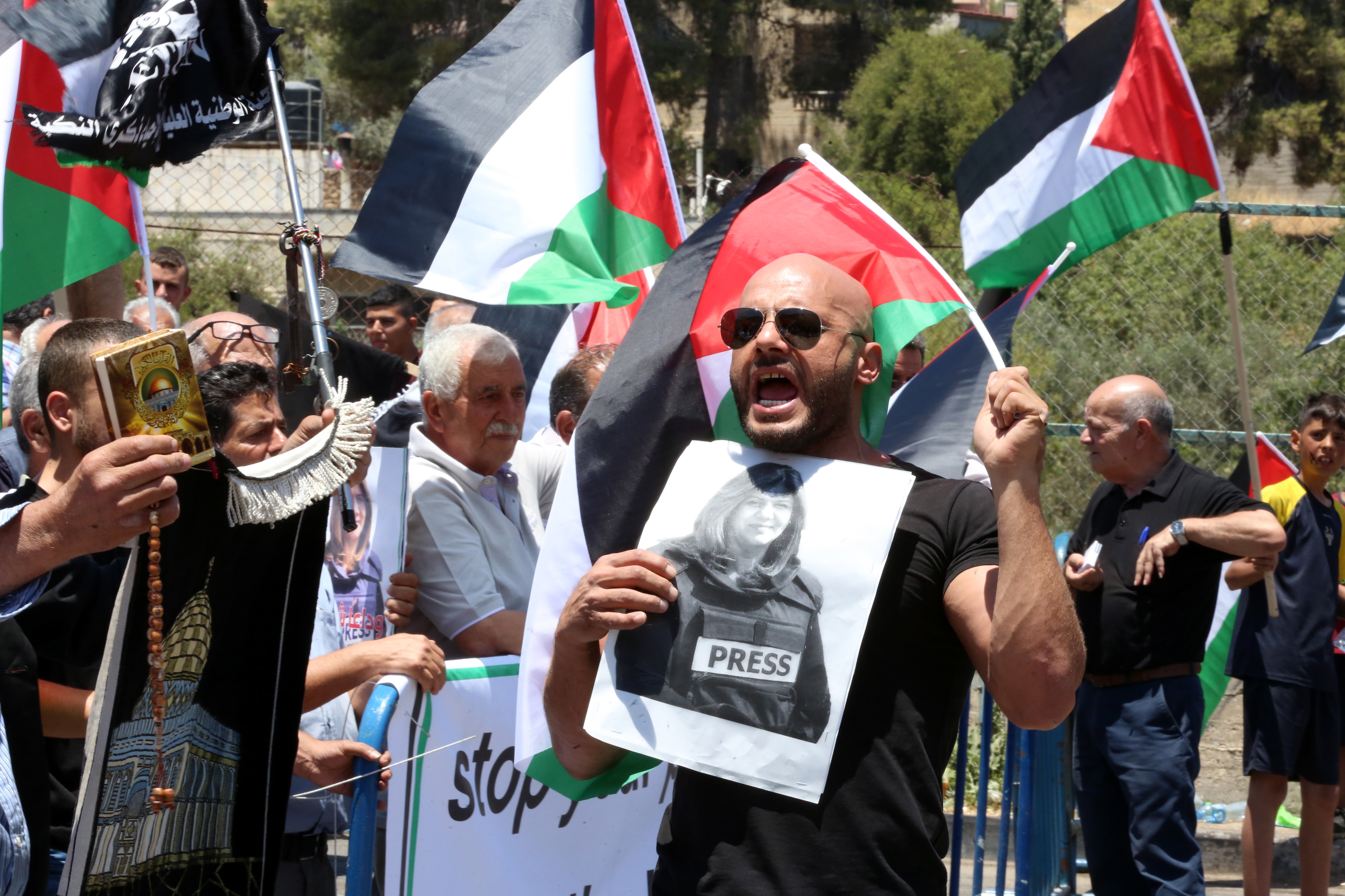 A man holds a photo of slain Palestinian-American journalist Shireen Abu Akleh during a protest at Dheisheh refugee camp, near Bethlehem