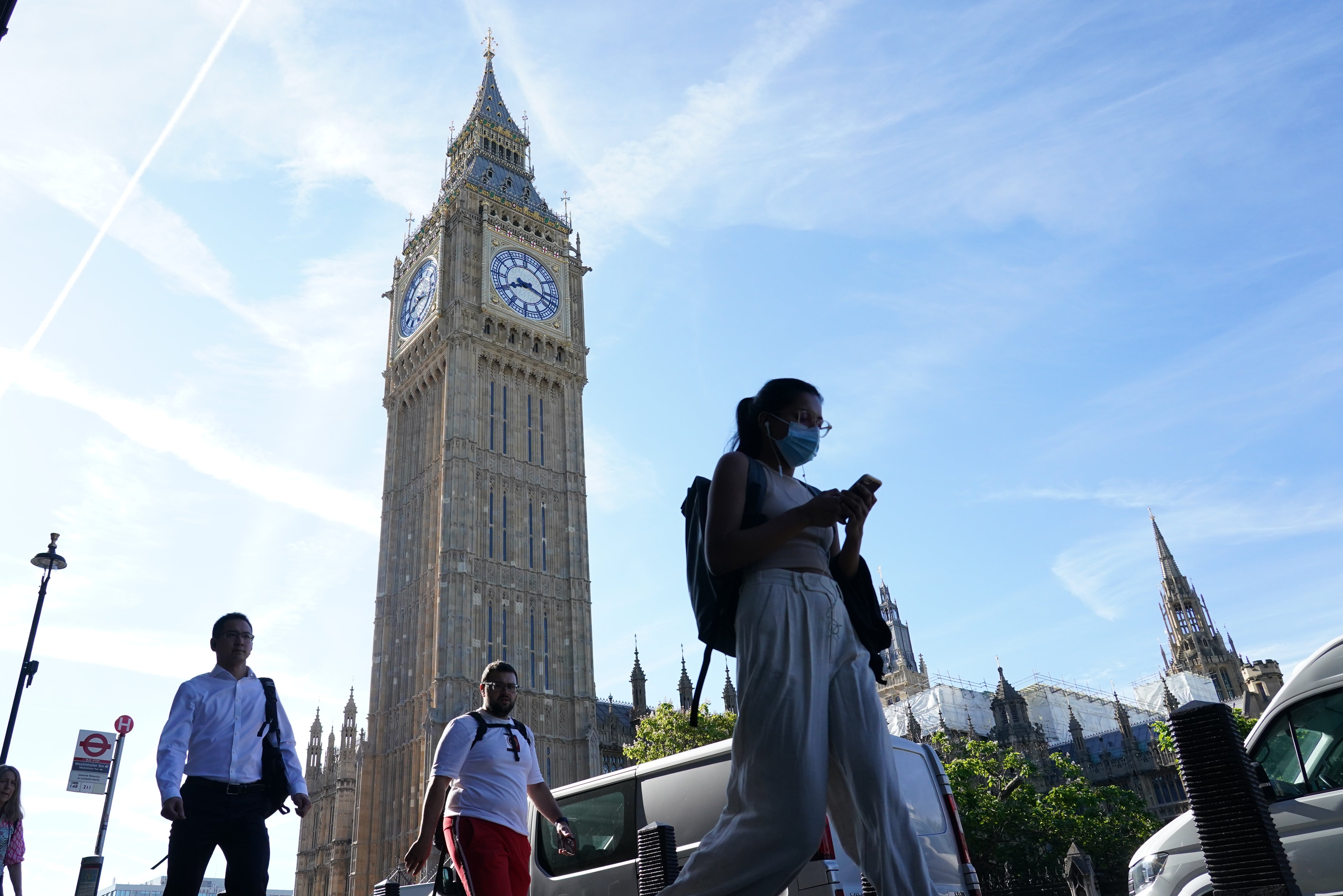 People walk past Big Ben at the Houses of Parliament in London on Friday.