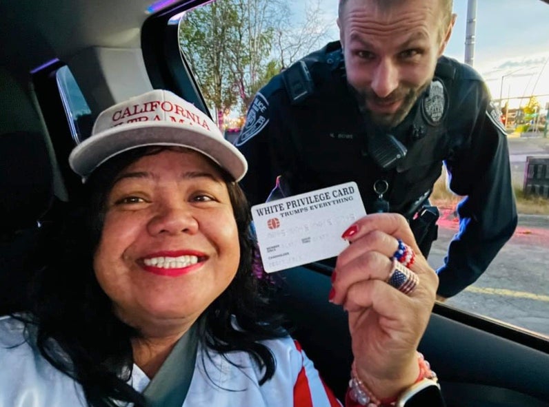 Mimi Israelah shared a selfie of herself and the officer smiling together as she proudly flashed the card to the camera