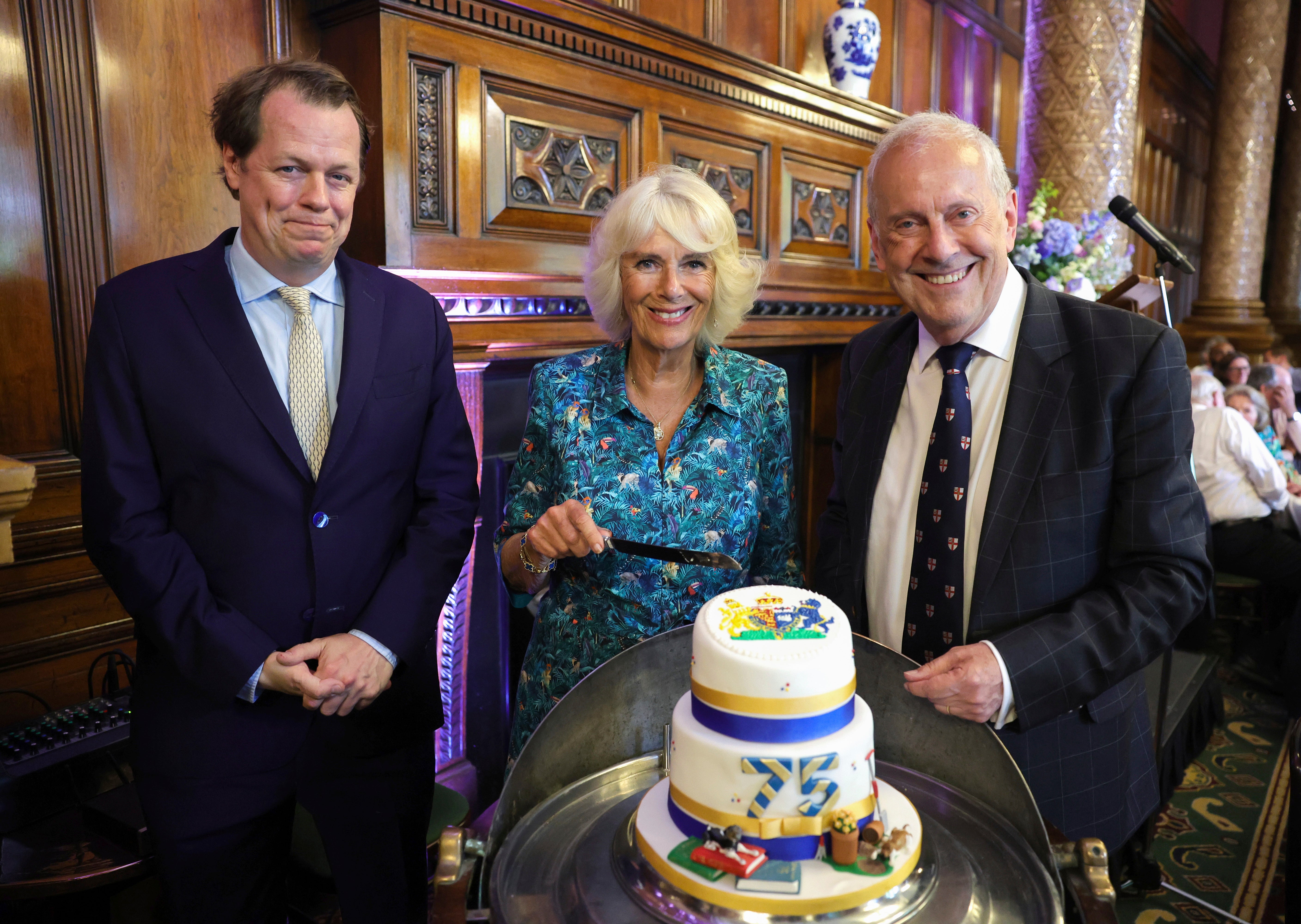 Tom Parker Bowles, left, Camilla, Duchess of Cornwall, and Gyles Brandreth, founder of Poetry Together, right, in 2022